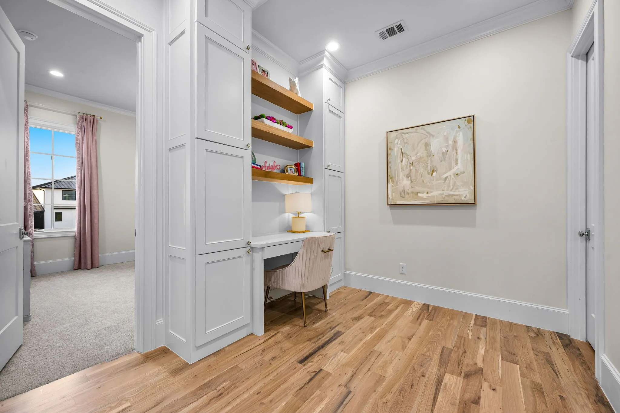 This loft area offers built in desk with storage along with walk in storage closet