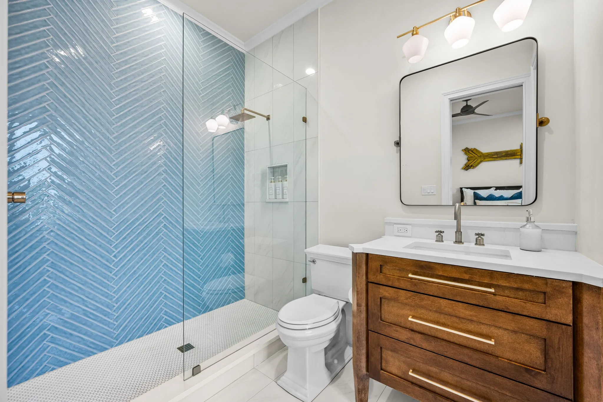 This vertical herringbone layout and color gives this bathroom such a bright look!