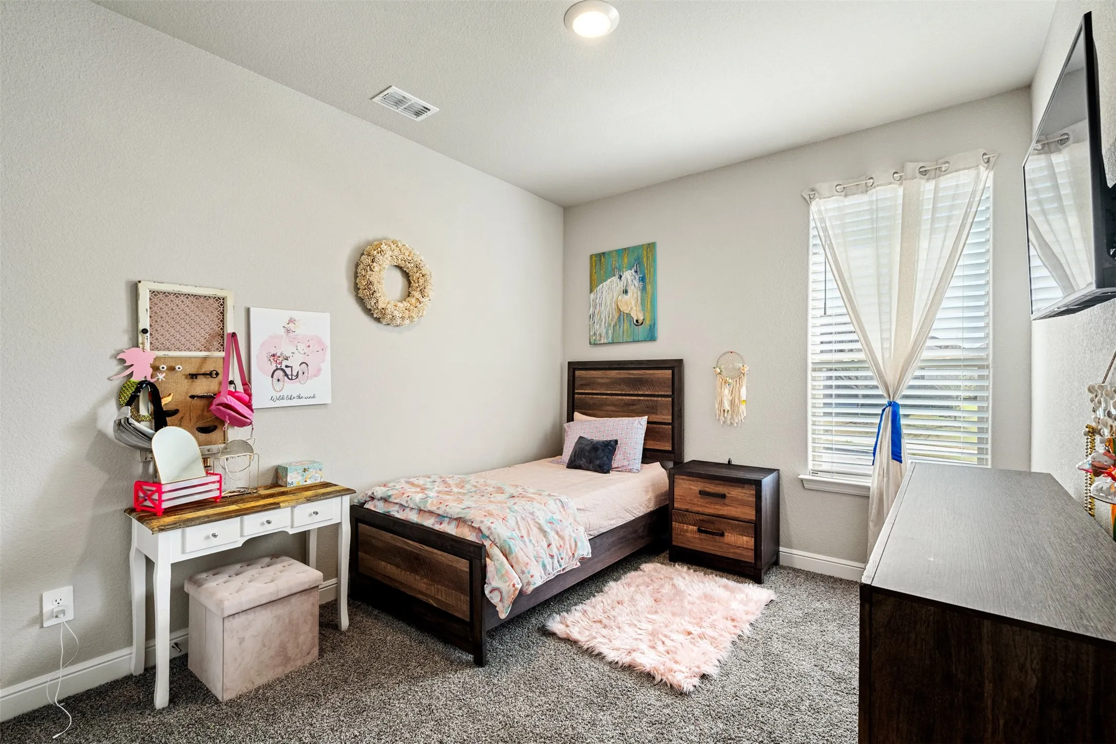 Carpeted bedroom featuring baseboards