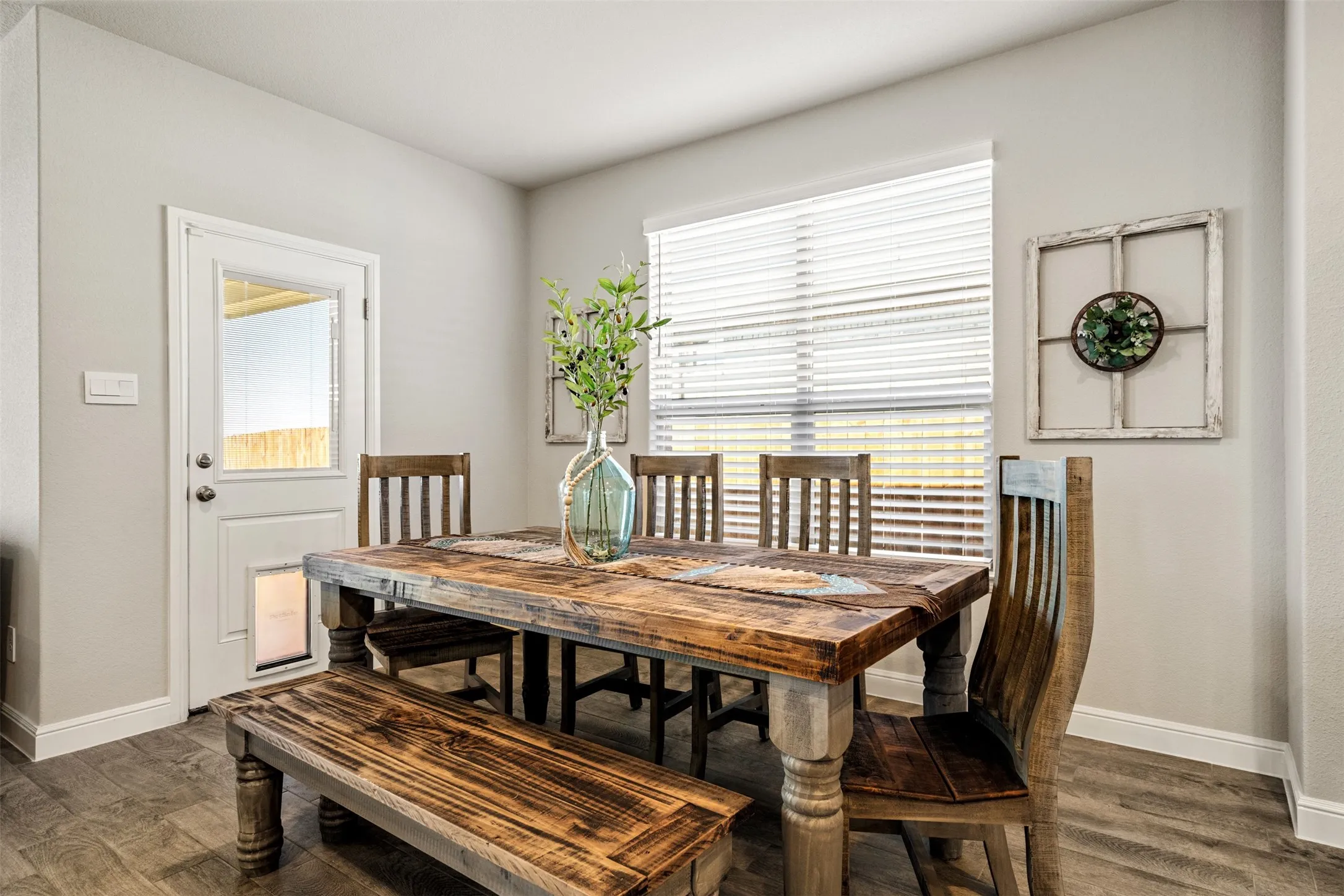 Dining area featuring dark wood finished floors and plenty of natural light
