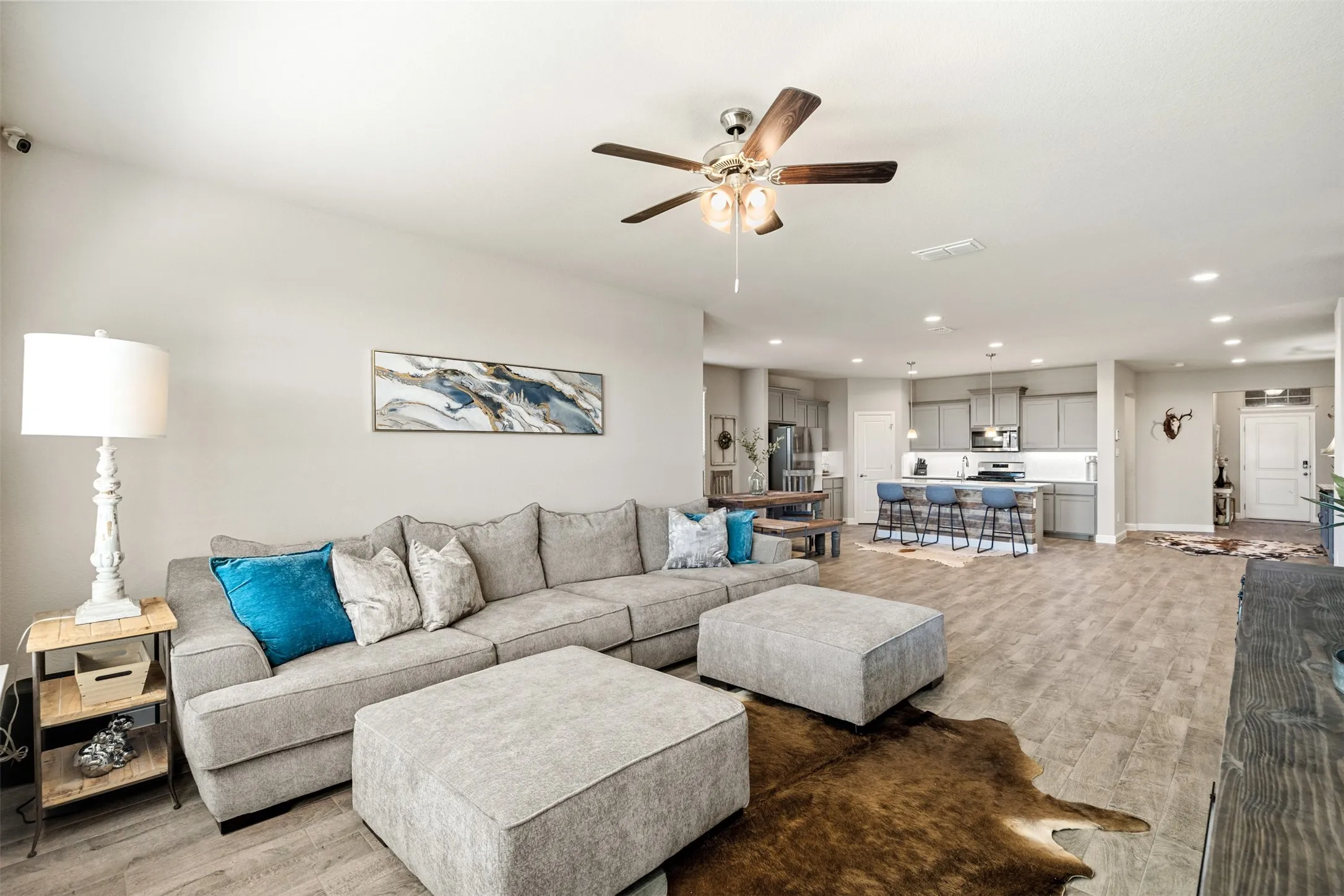 Living room with light wood-style floors, recessed lighting, and a ceiling fan