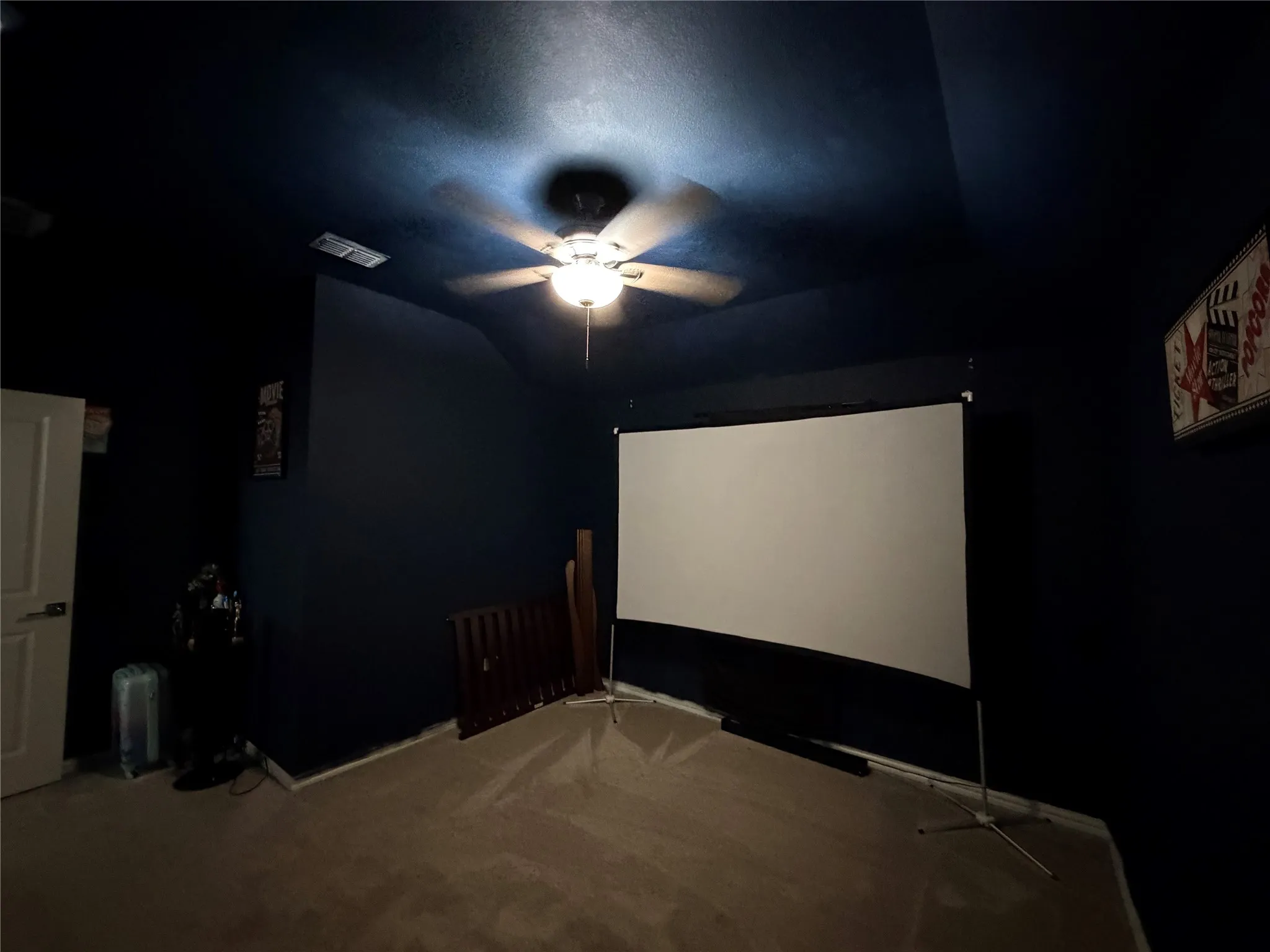 Cinema with ceiling fan, carpet, and lofted ceiling
