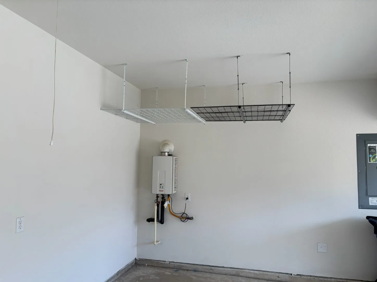 Tankless hot water heater and hanging storage in the garage
