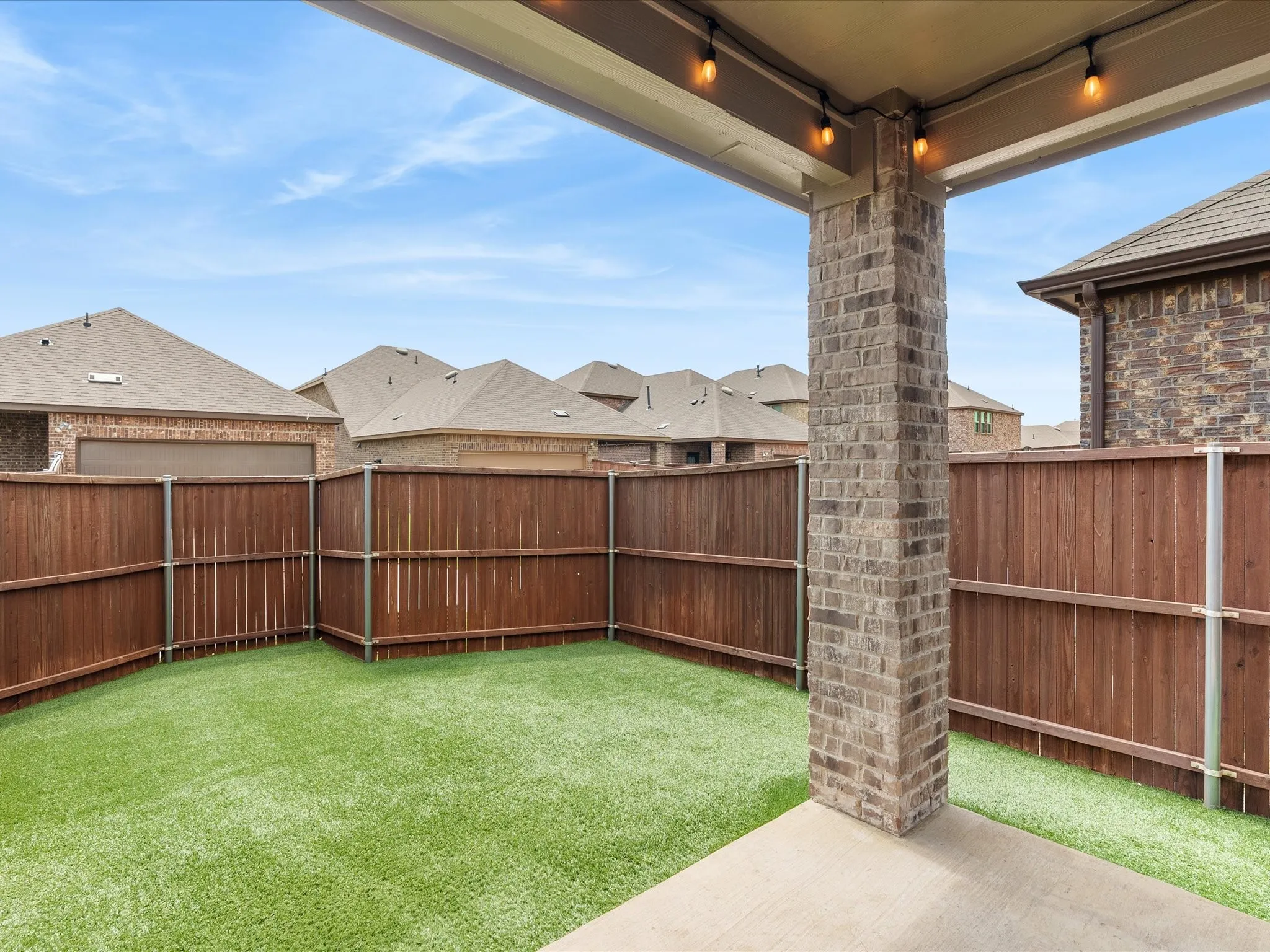 Low-maintenance backyard featuring artificial turf for year-round enjoyment with minimal upkeep.
