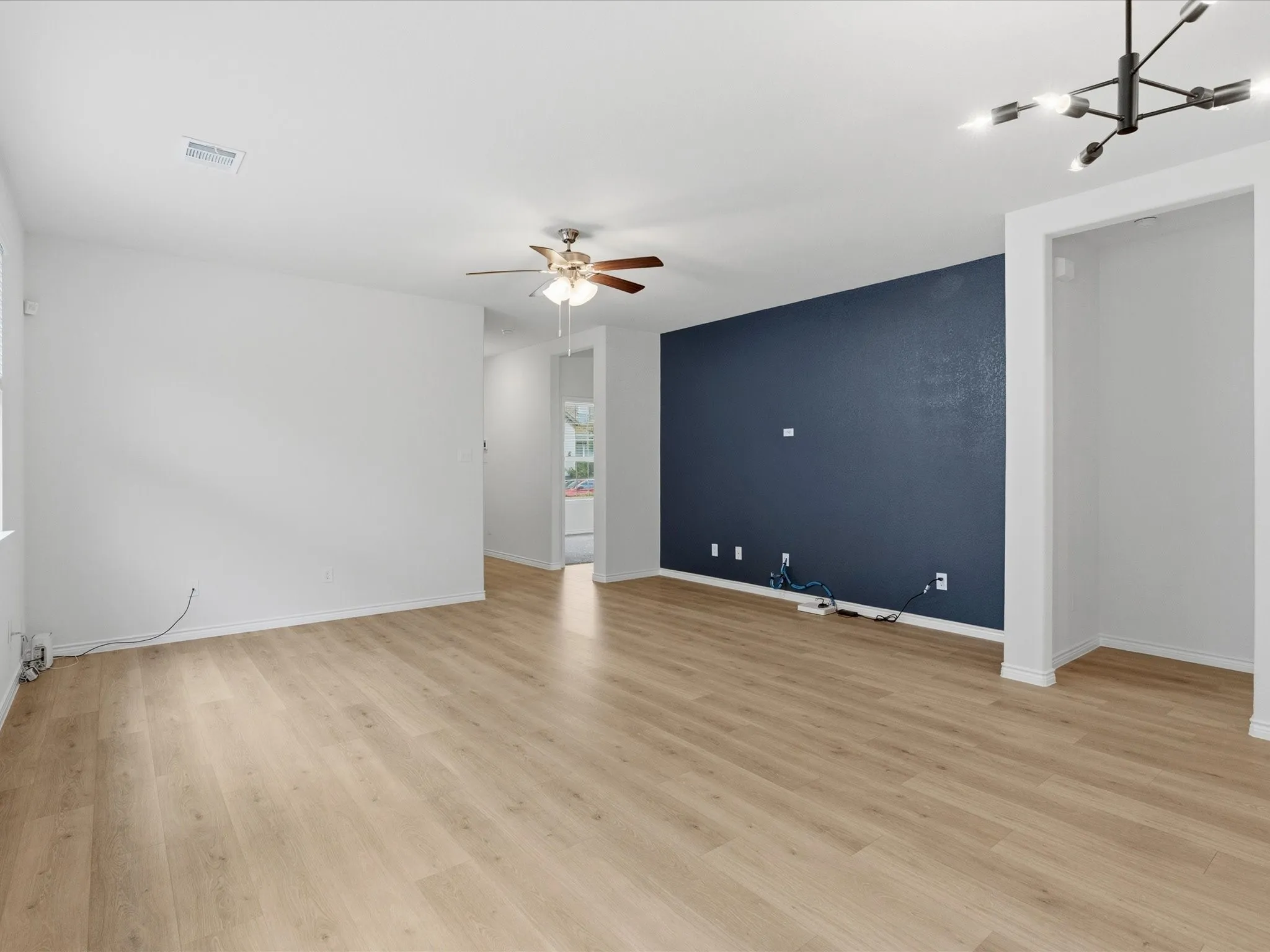 Flooring has a sandy gray color in person. Photography lights make it look a little more tan than it is.