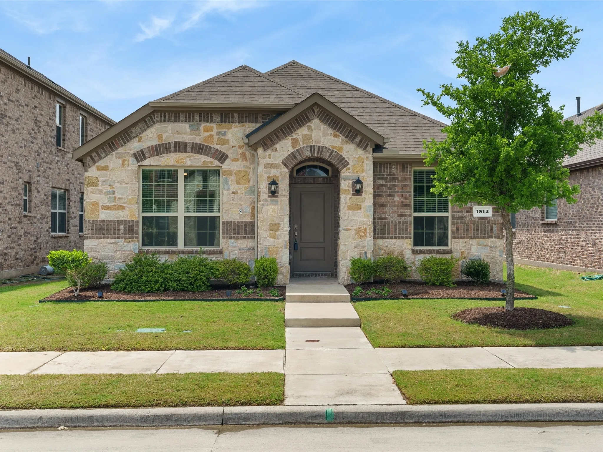 Welcome to 1513 Babb Ln. Charming brick exterior with inviting curb appeal and modern landscaping.