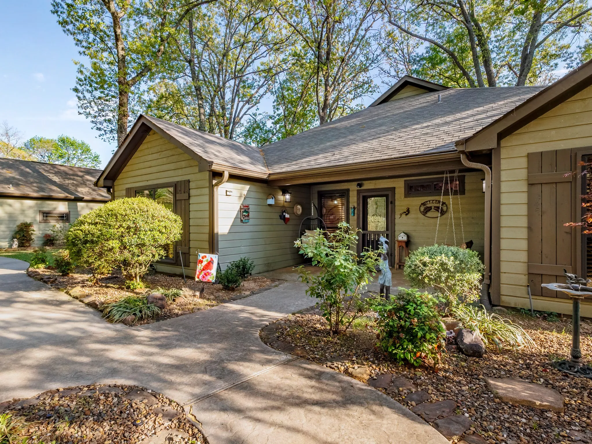 View of exterior entry with roof with shingles