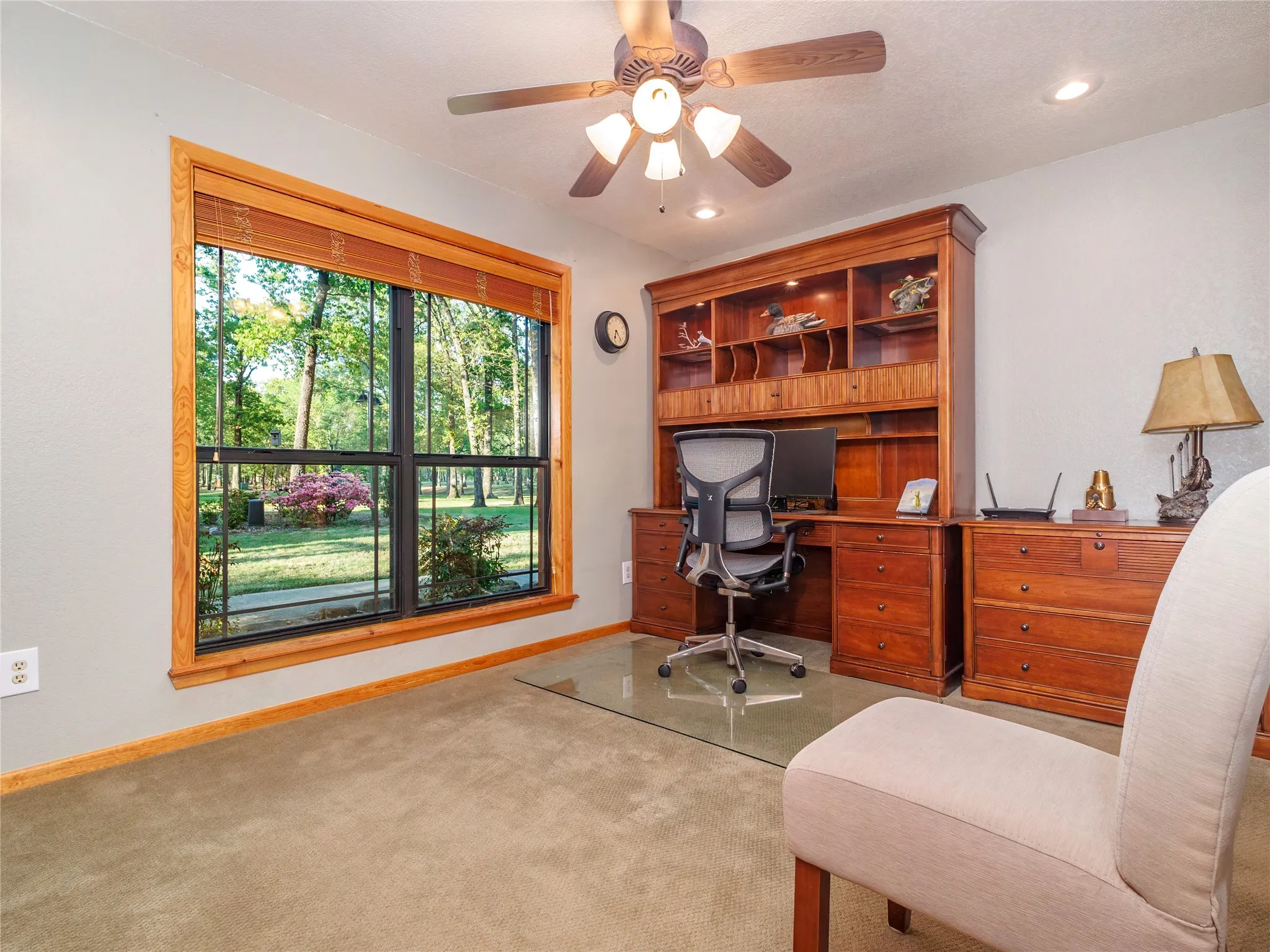Carpeted home office featuring a ceiling fan and recessed lighting