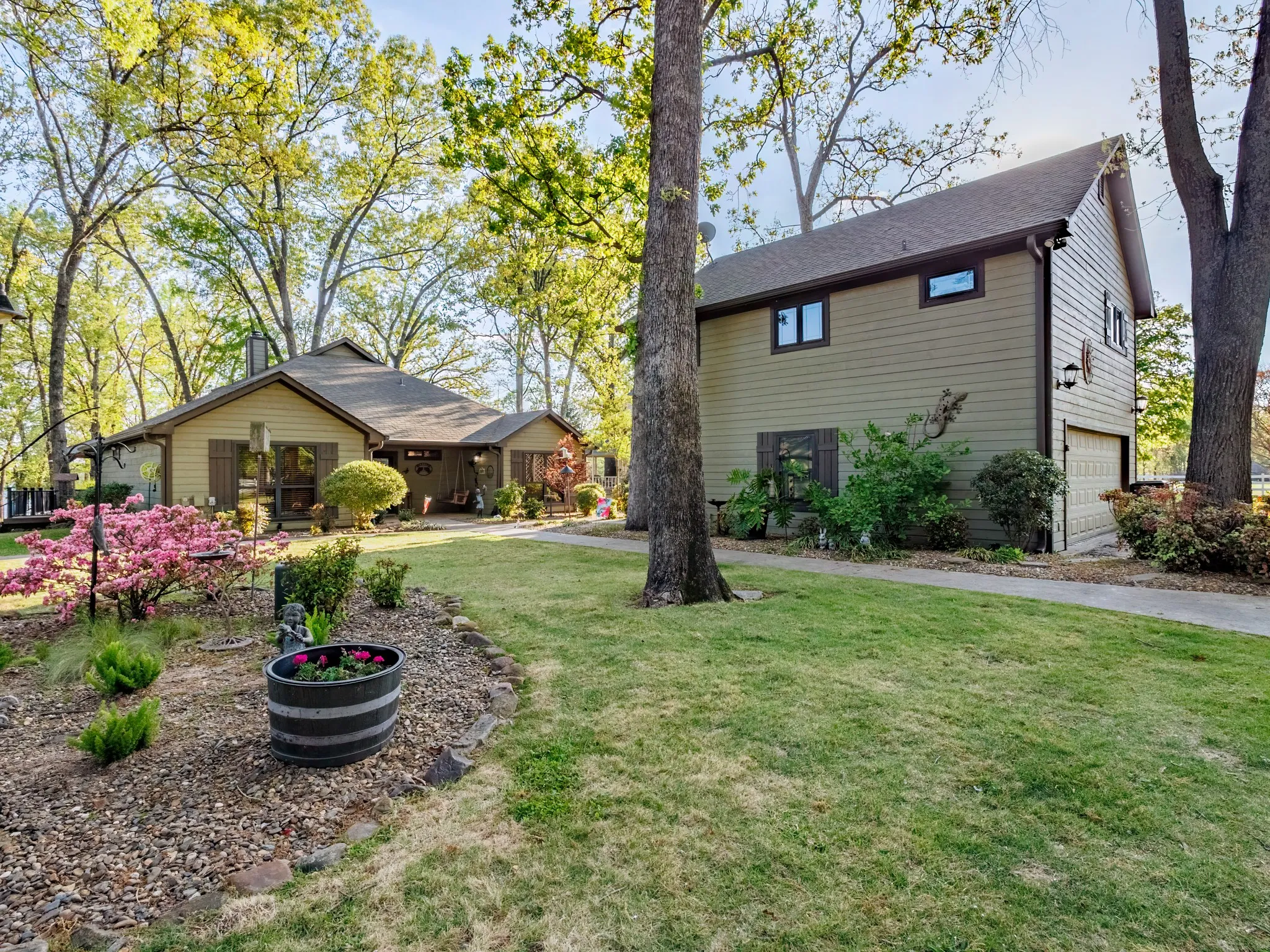 Beautiful Landscaping with view of Guest Quarters and Garage in background