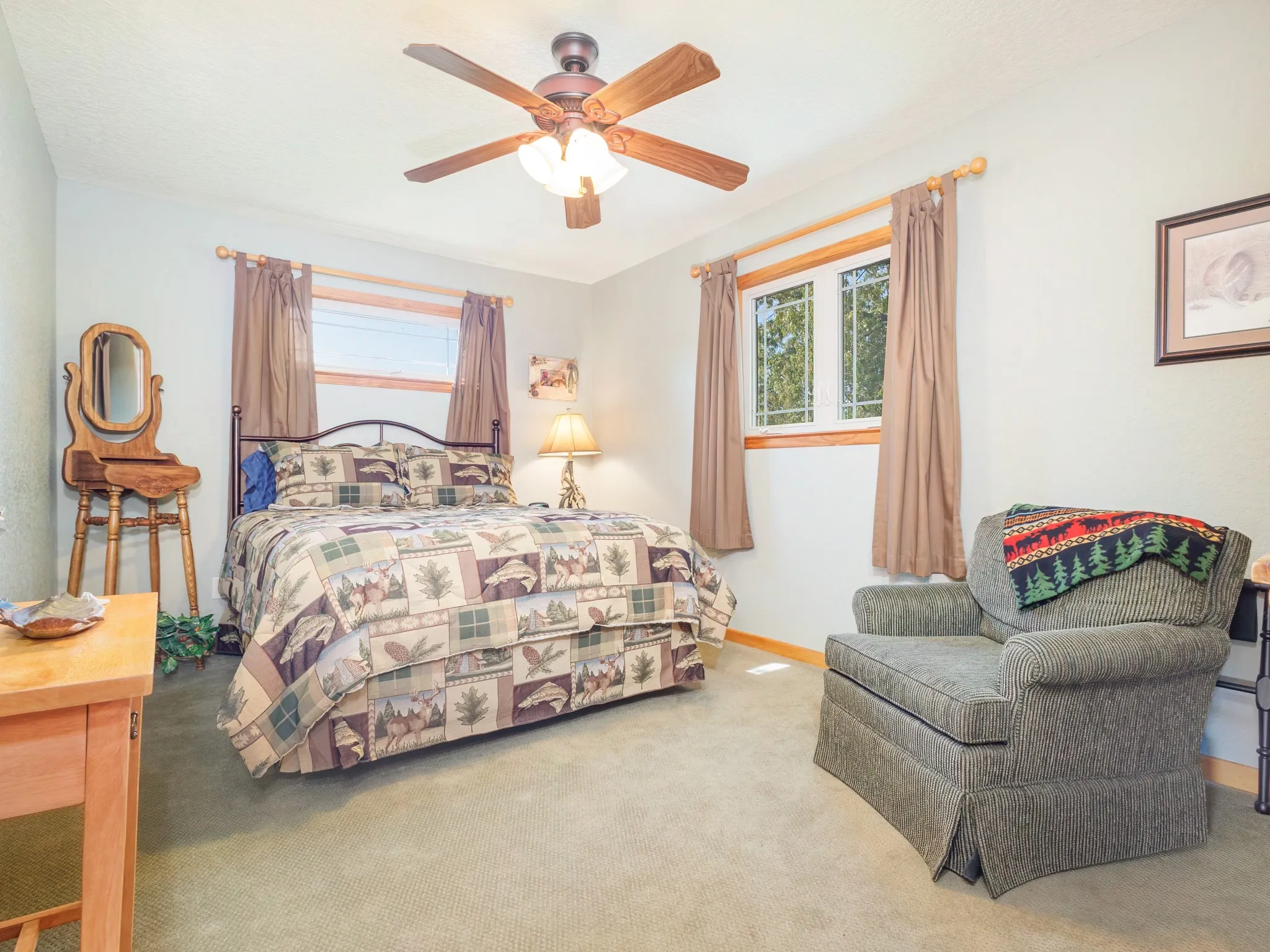 Guest Quarters bedroom with a ceiling fan and baseboards