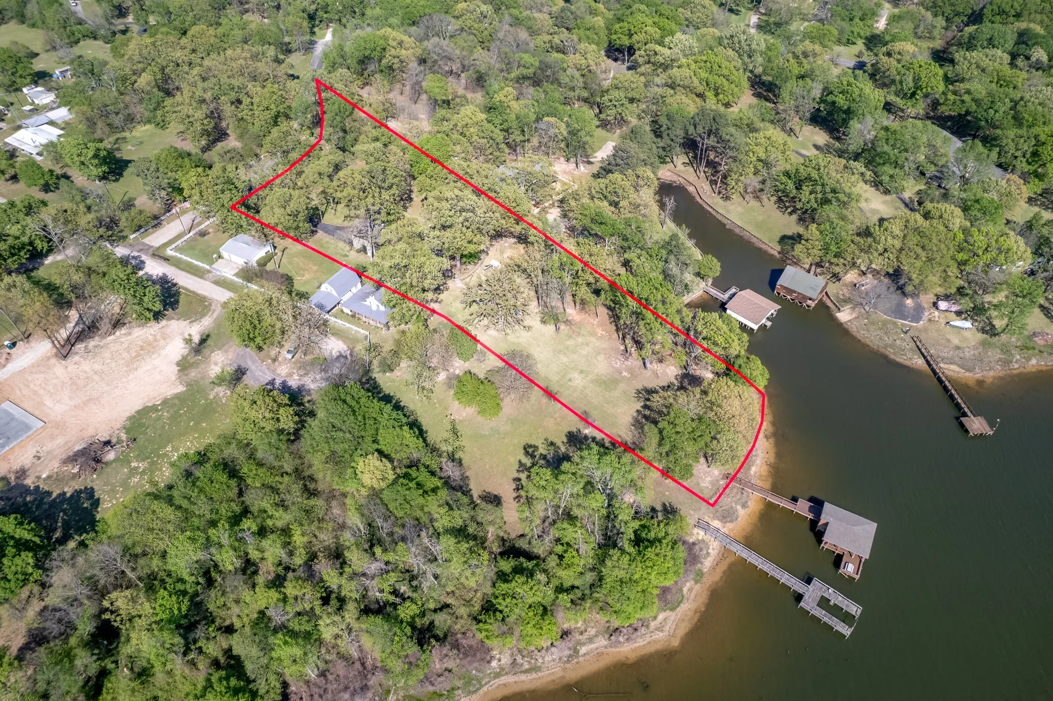 Aerial view of property's location with property boundaries highlighted and a large body of water