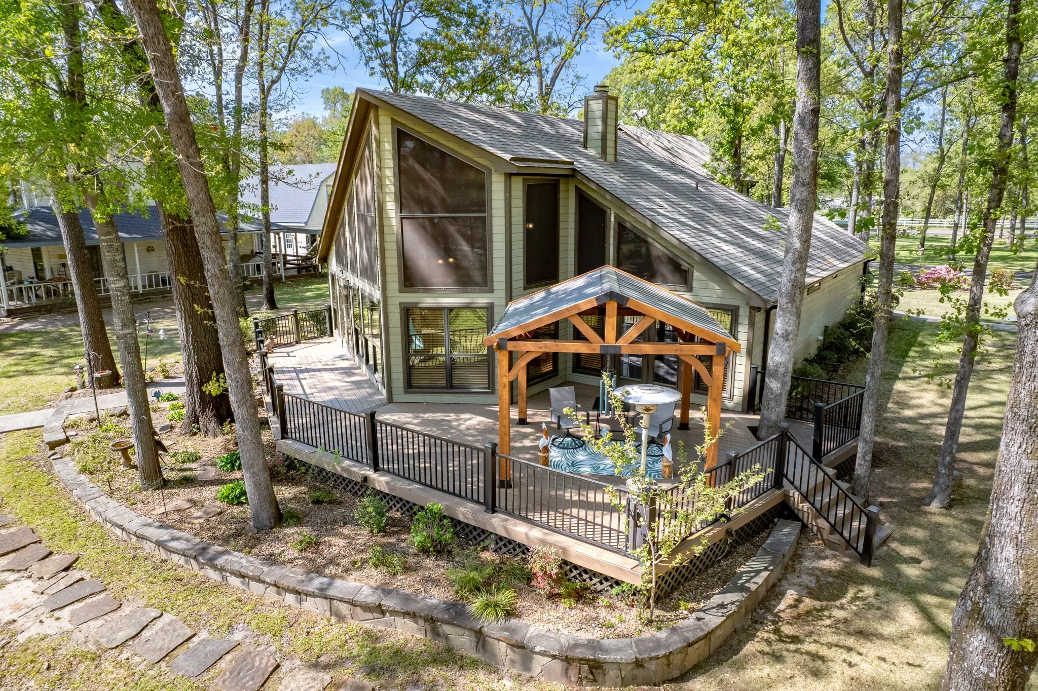 View of outbuilding featuring a sunroom and stairs
