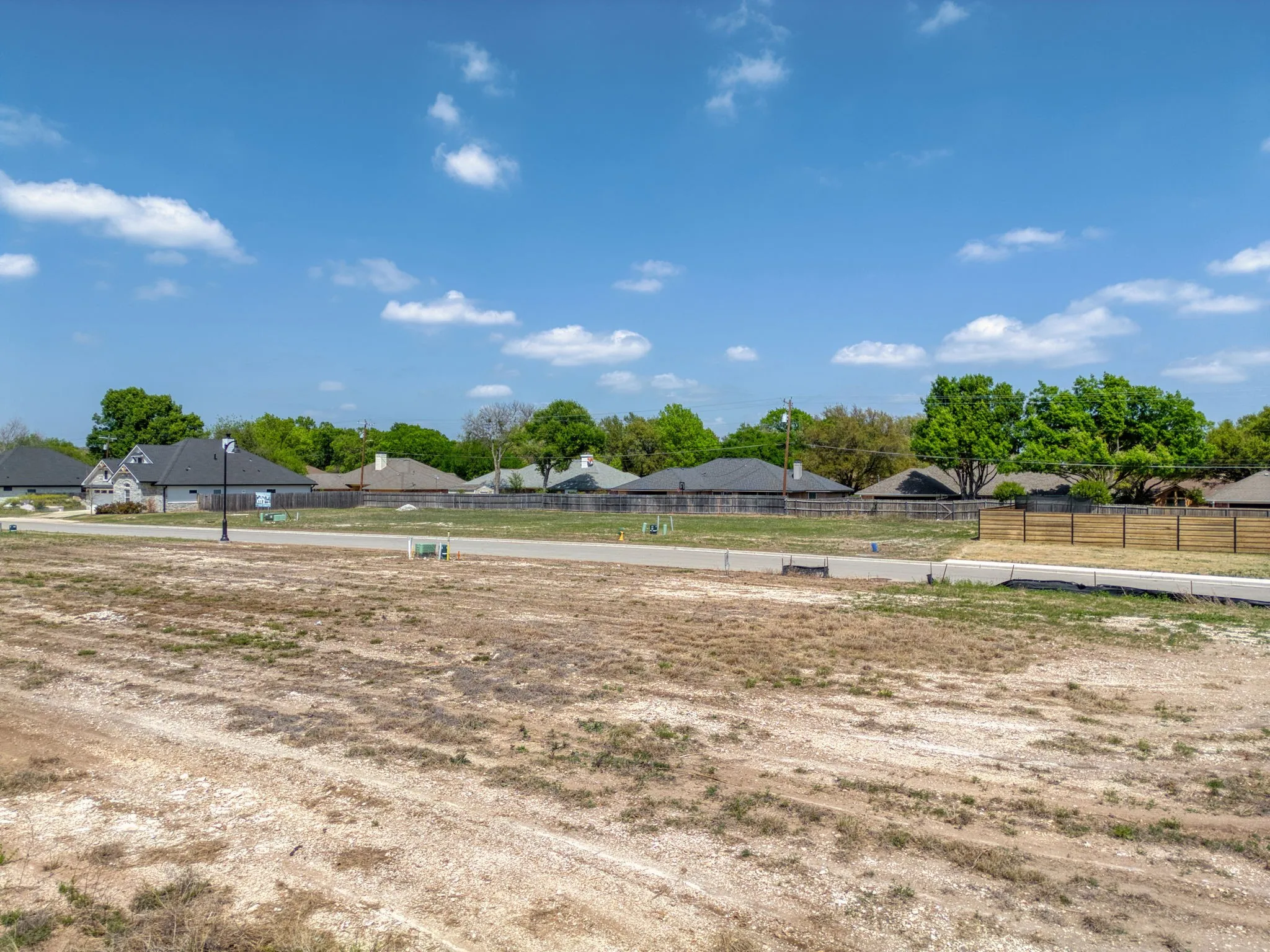 View of yard with an outdoor riding arena and a residential view