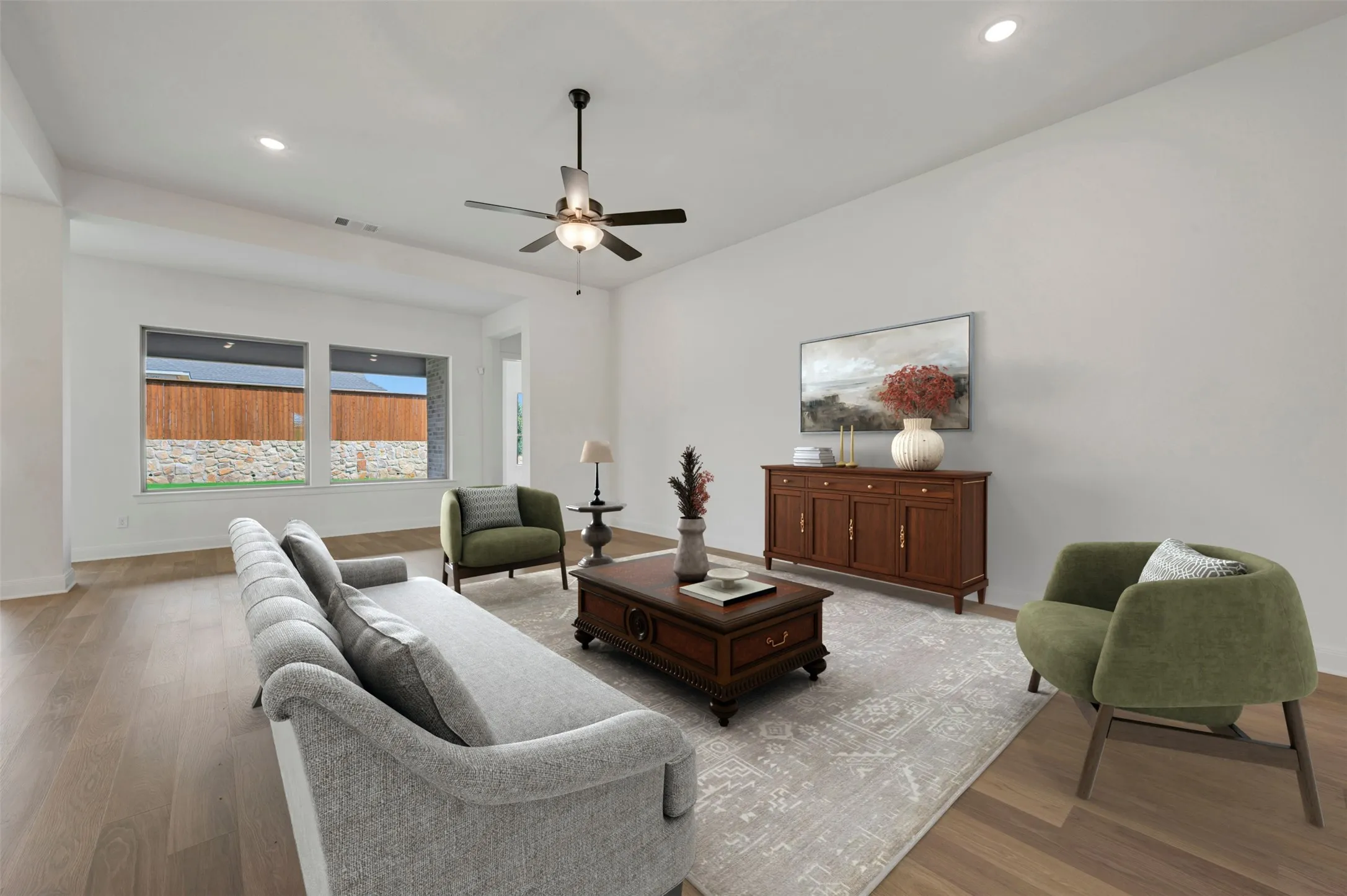 Recessed lighting, wood-finish flooring, ceiling fan with integrated lighting, two horizontal windows, and white painted walls