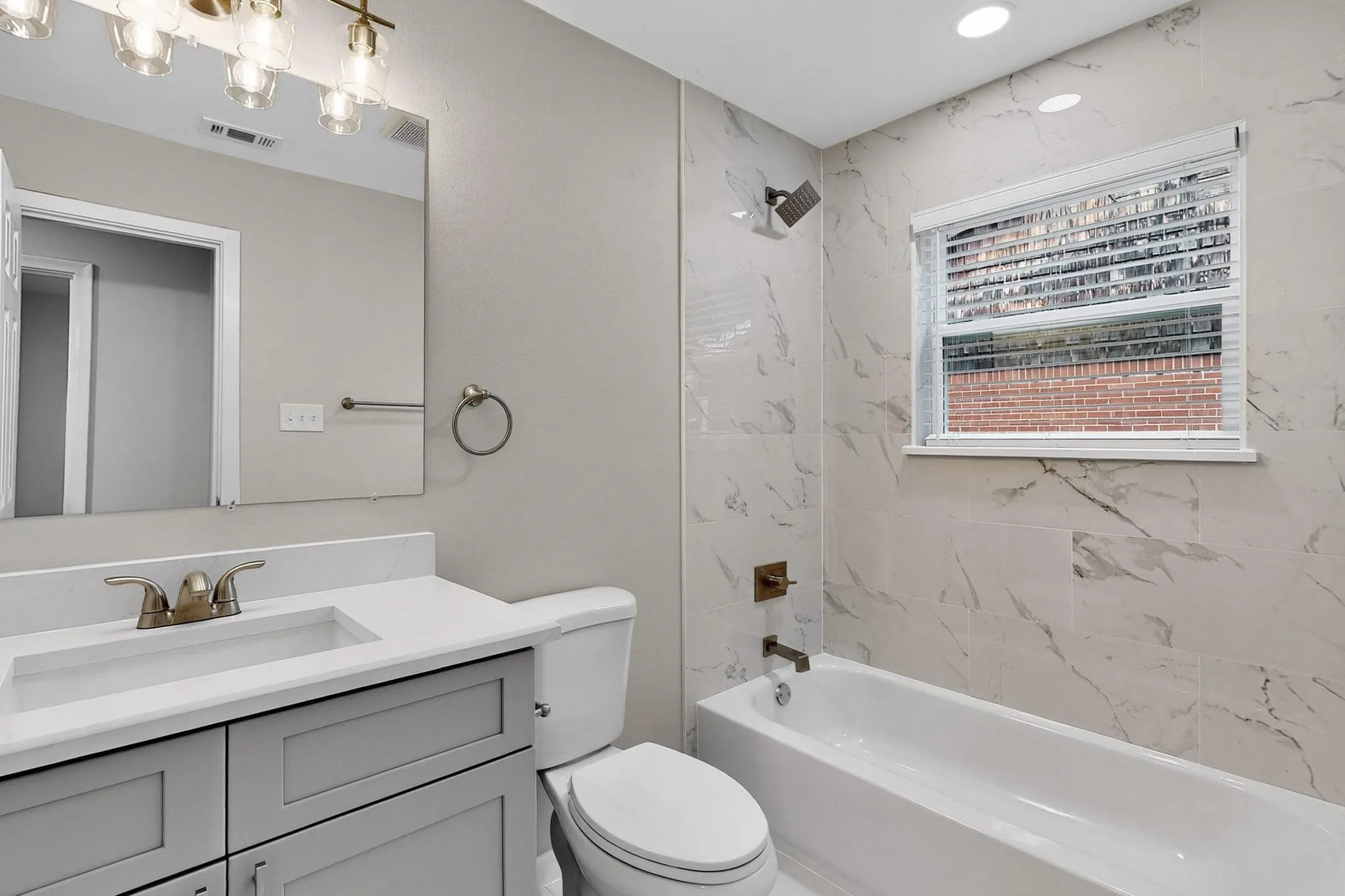 Full bathroom featuring vanity and shower / washtub combination