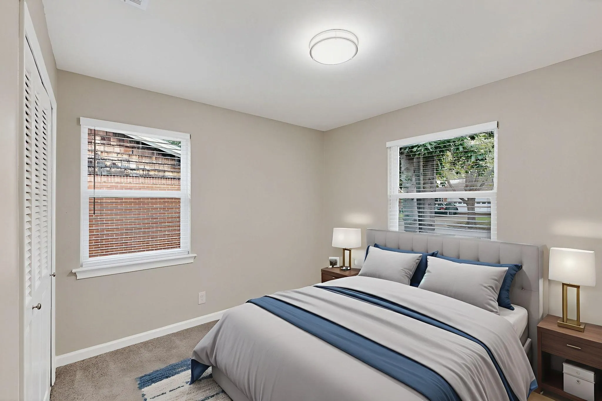 Bedroom with light carpet and a closet