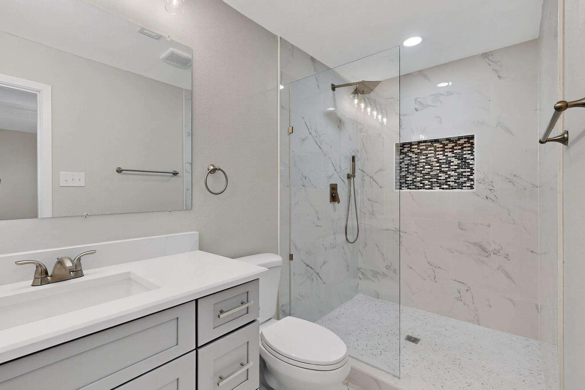 Full bathroom with vanity and a marble finish shower