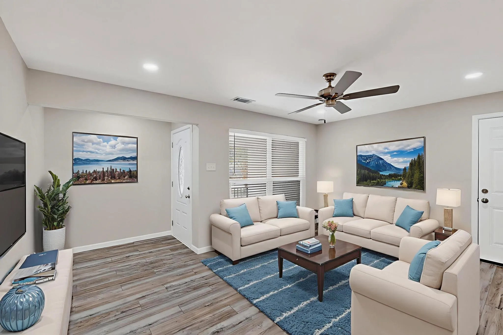 Living room with ceiling fan, light wood-style floors, and recessed lighting