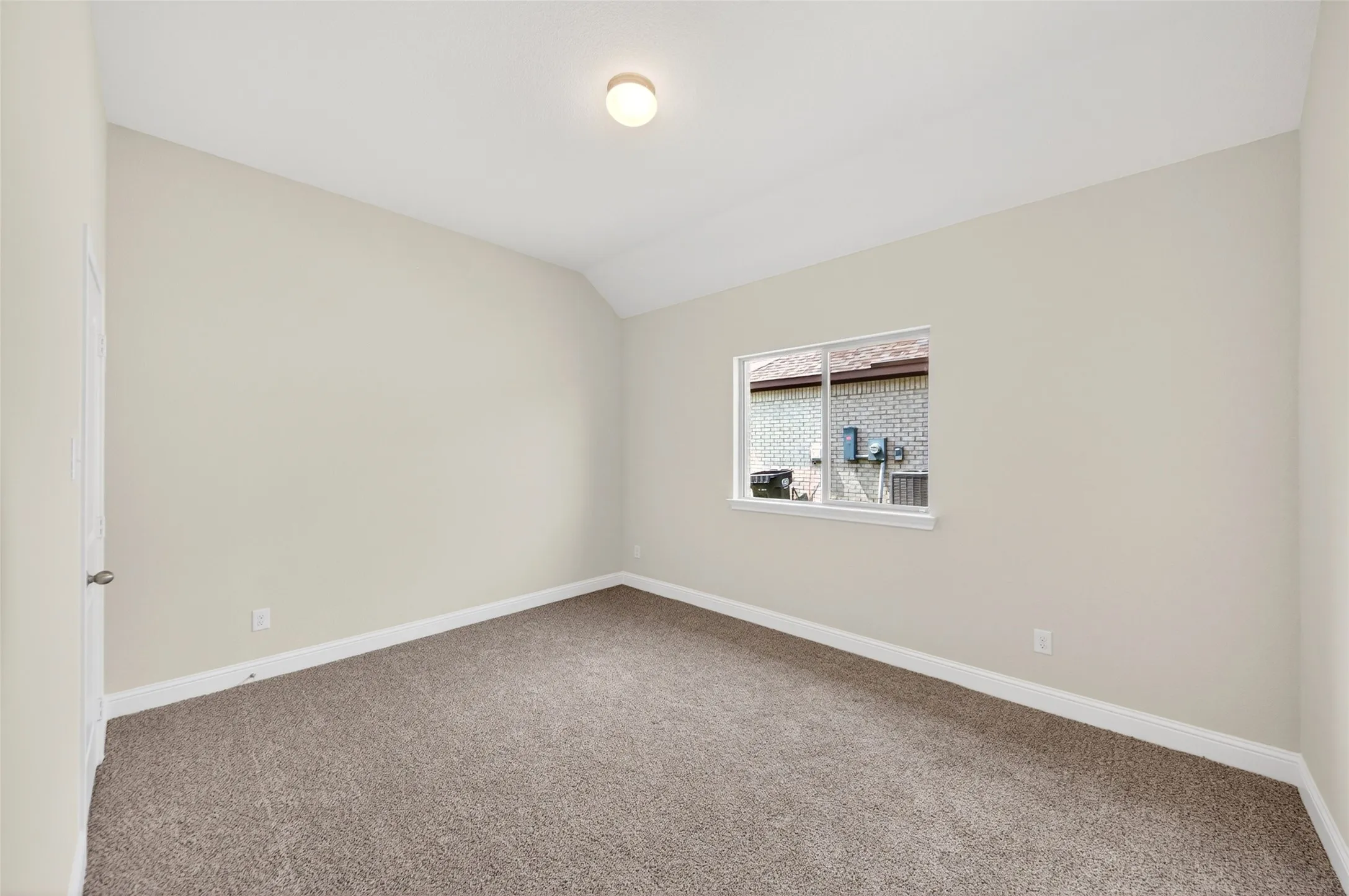 Neutral-toned walls complement the brown carpet flooring