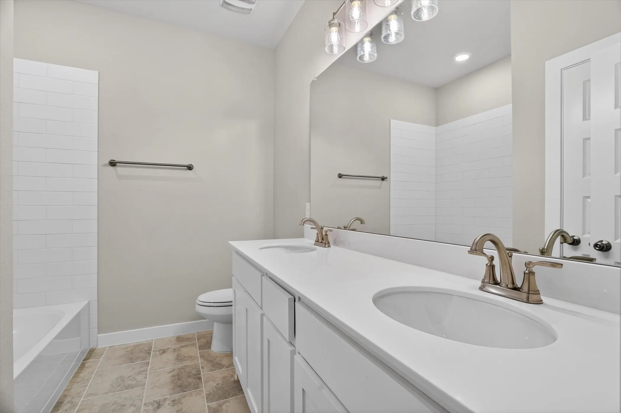 Bathroom featuring a double vanity with white cabinetry and integrated sinks
