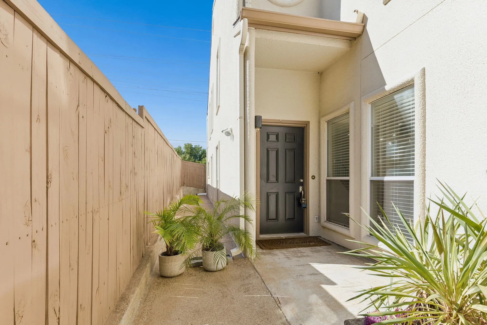 Entrance to property with stucco siding