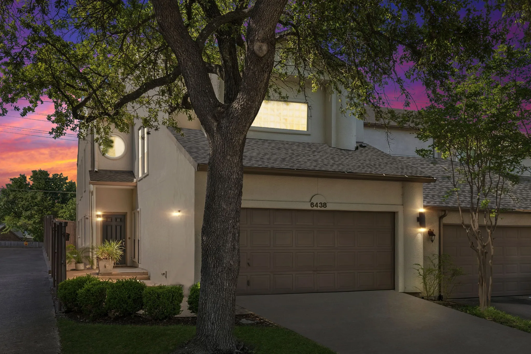 View of front of home featuring a NEW shingled roof, driveway, and stucco siding