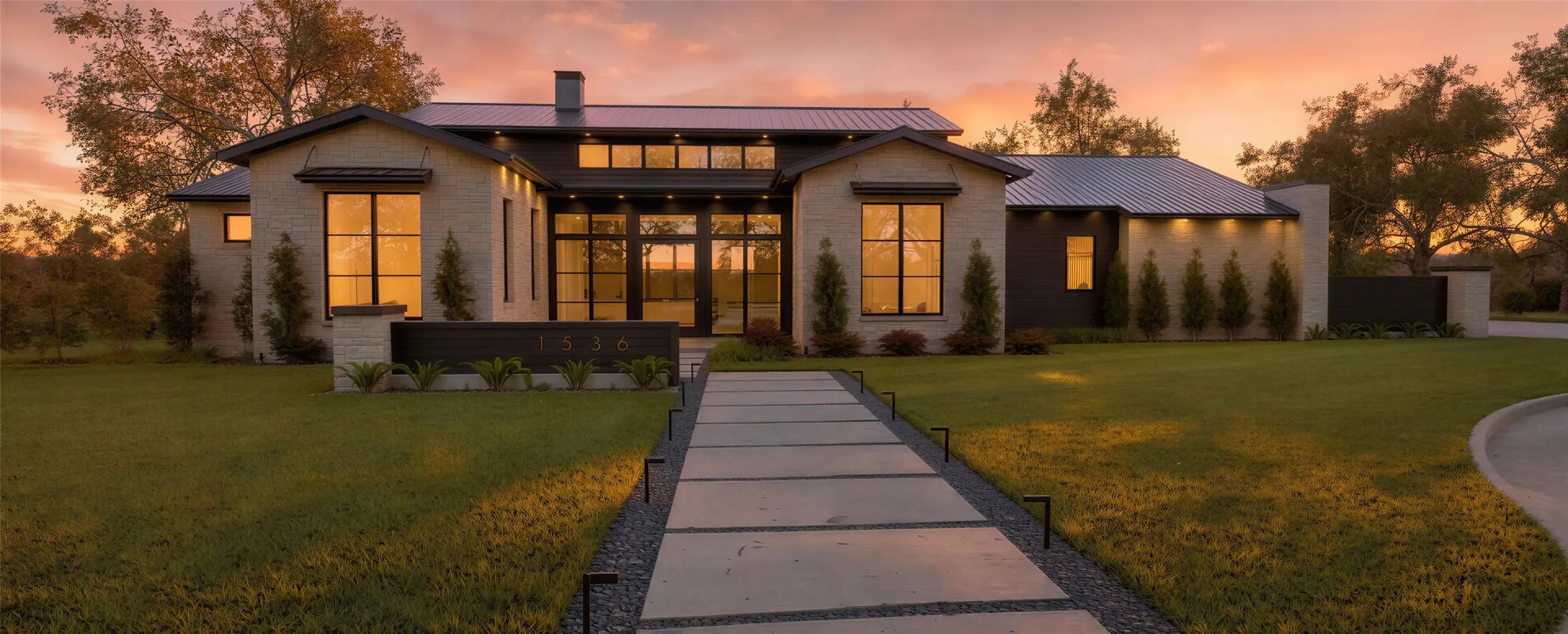 View of front facade featuring a front lawn, a standing seam roof, and a chimney