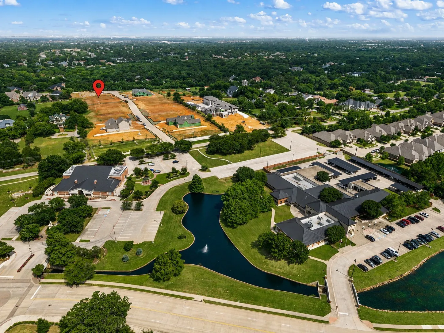 Aerial perspective showcasing undeveloped land parcels surrounded by established residential areas and commercial properties