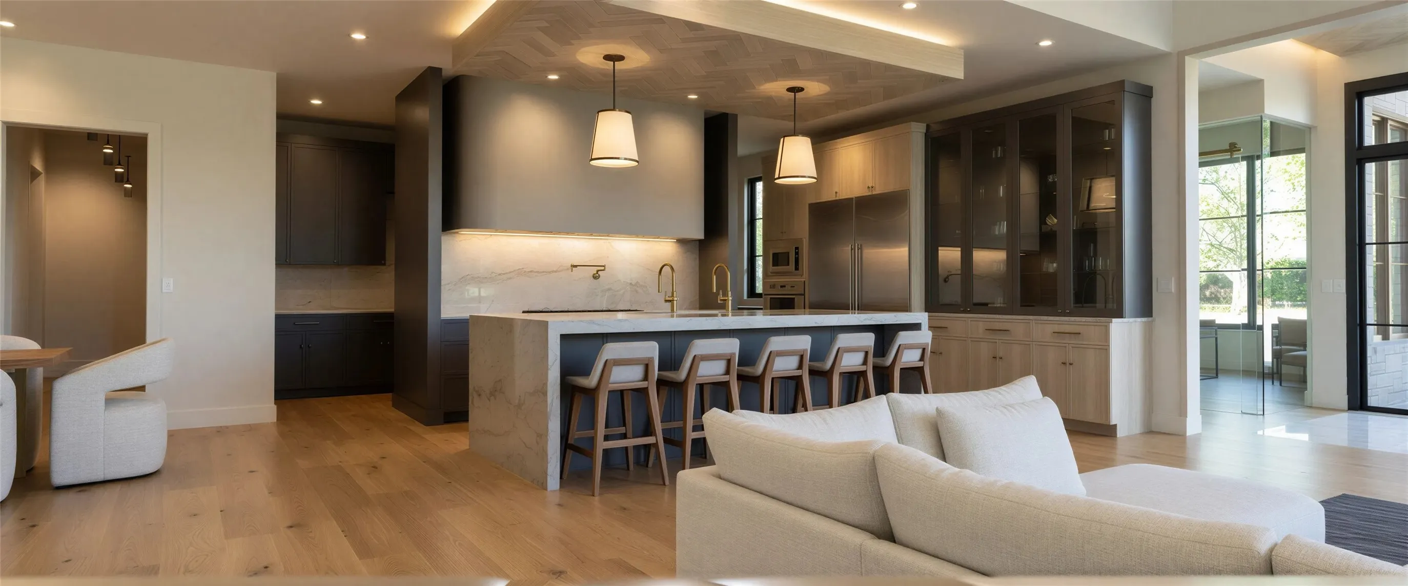 Kitchen with open floor plan, a kitchen island with sink, hanging light fixtures, and stainless steel appliances