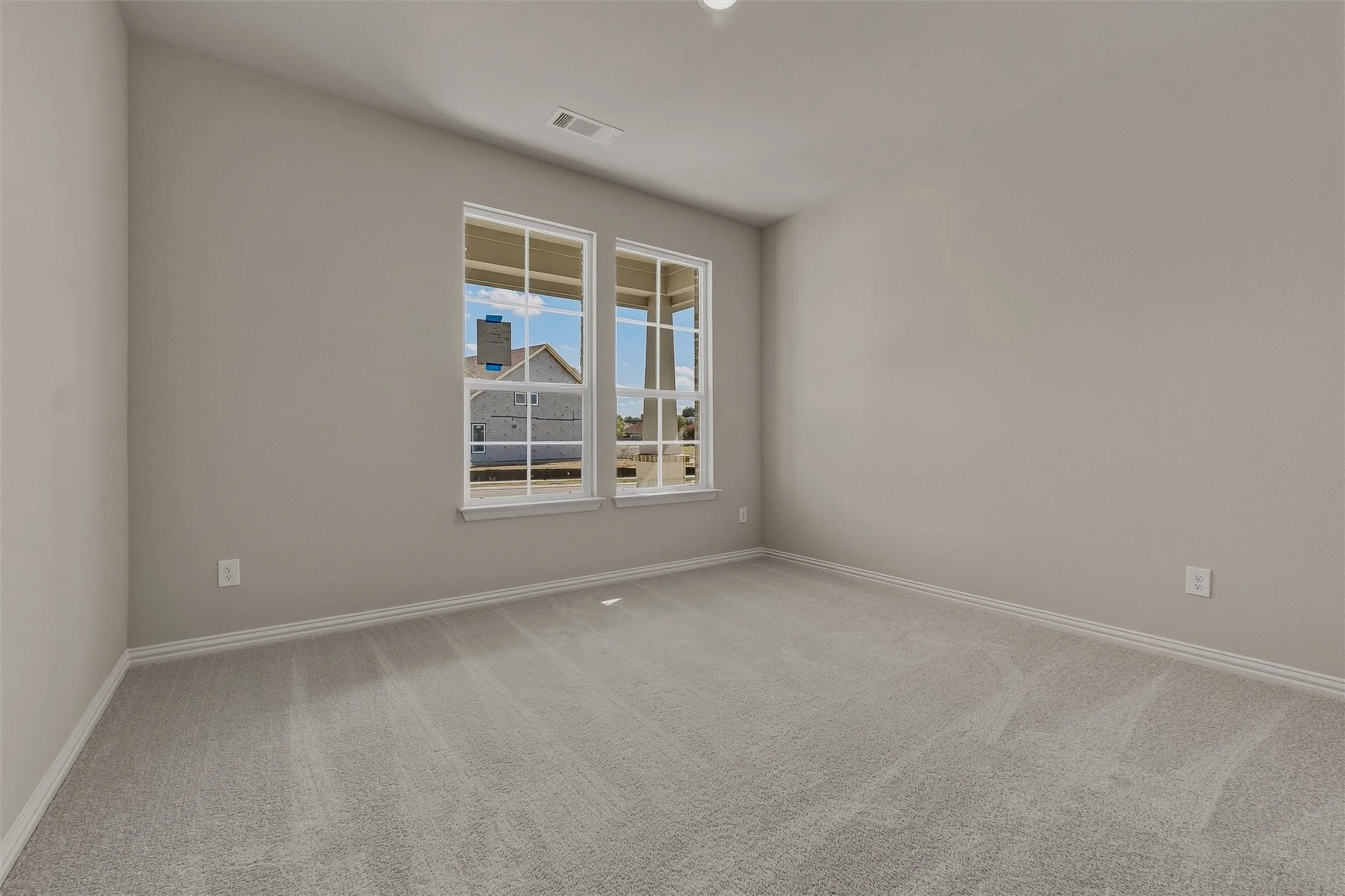 Wall-to-wall carpeting, dual windows, and neutral wall tones