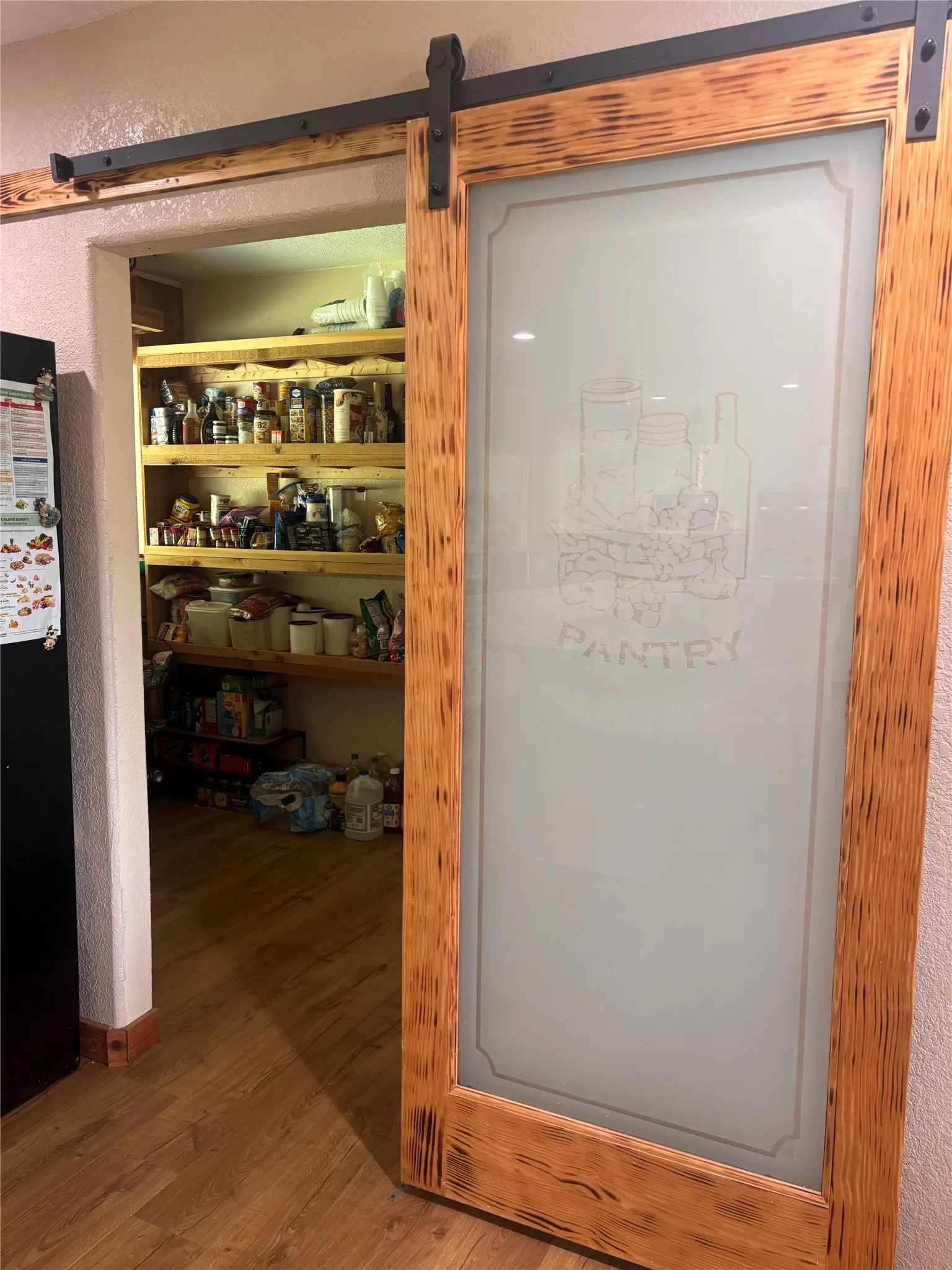 Custom wood-framed barn door with frosted glass insert