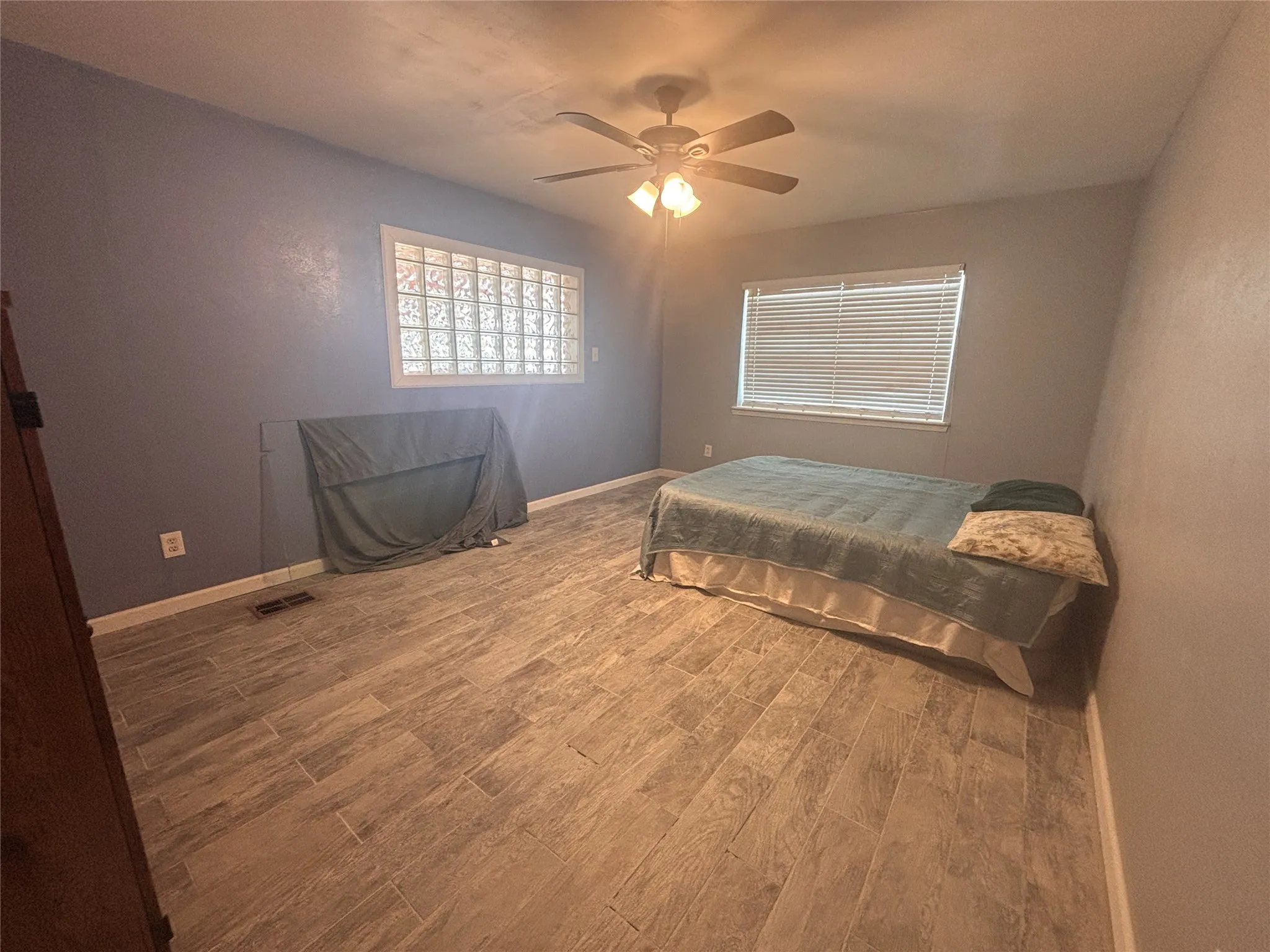 Room featuring tile flooring and a ceiling fan with integrated lighting