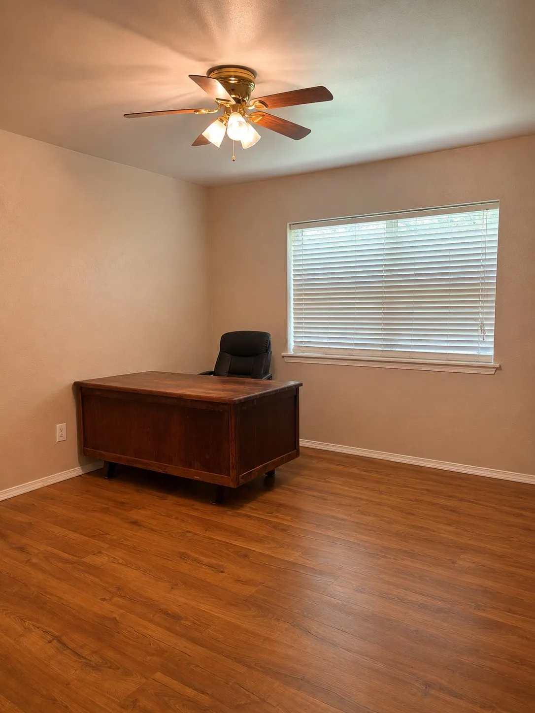Warm-toned wood-finish flooring complements the neutral wall color
(AI Enhanced / Object removal)