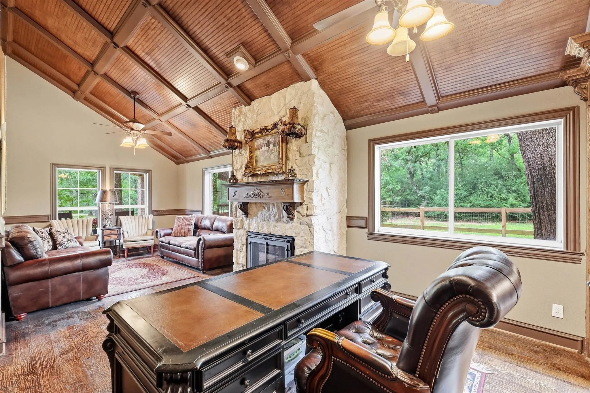 Office has room for large couches, wood ceiling
