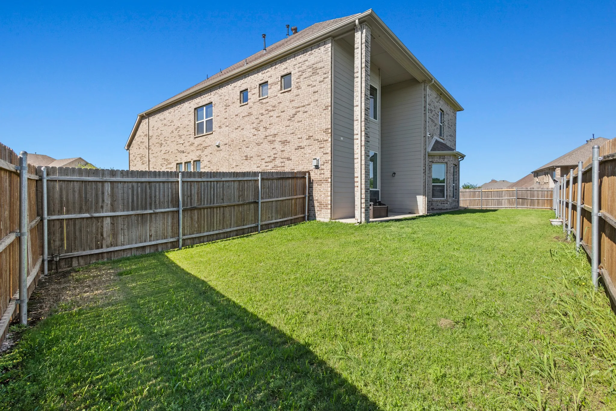 Back of property featuring brick siding