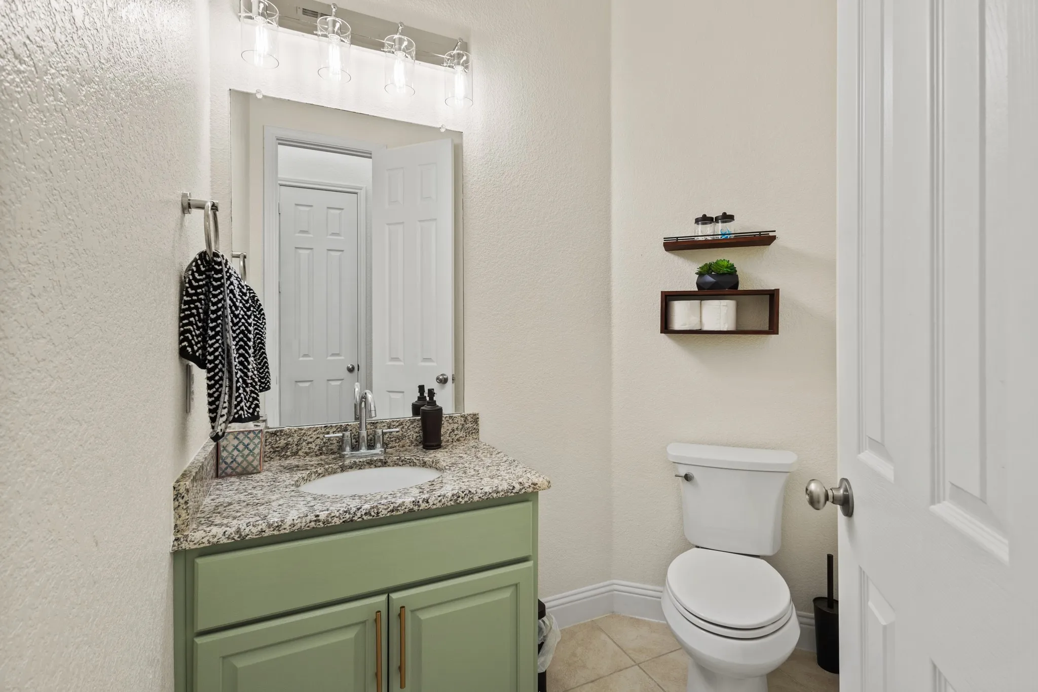 Bathroom with tile patterned flooring, vanity, toilet, and baseboards