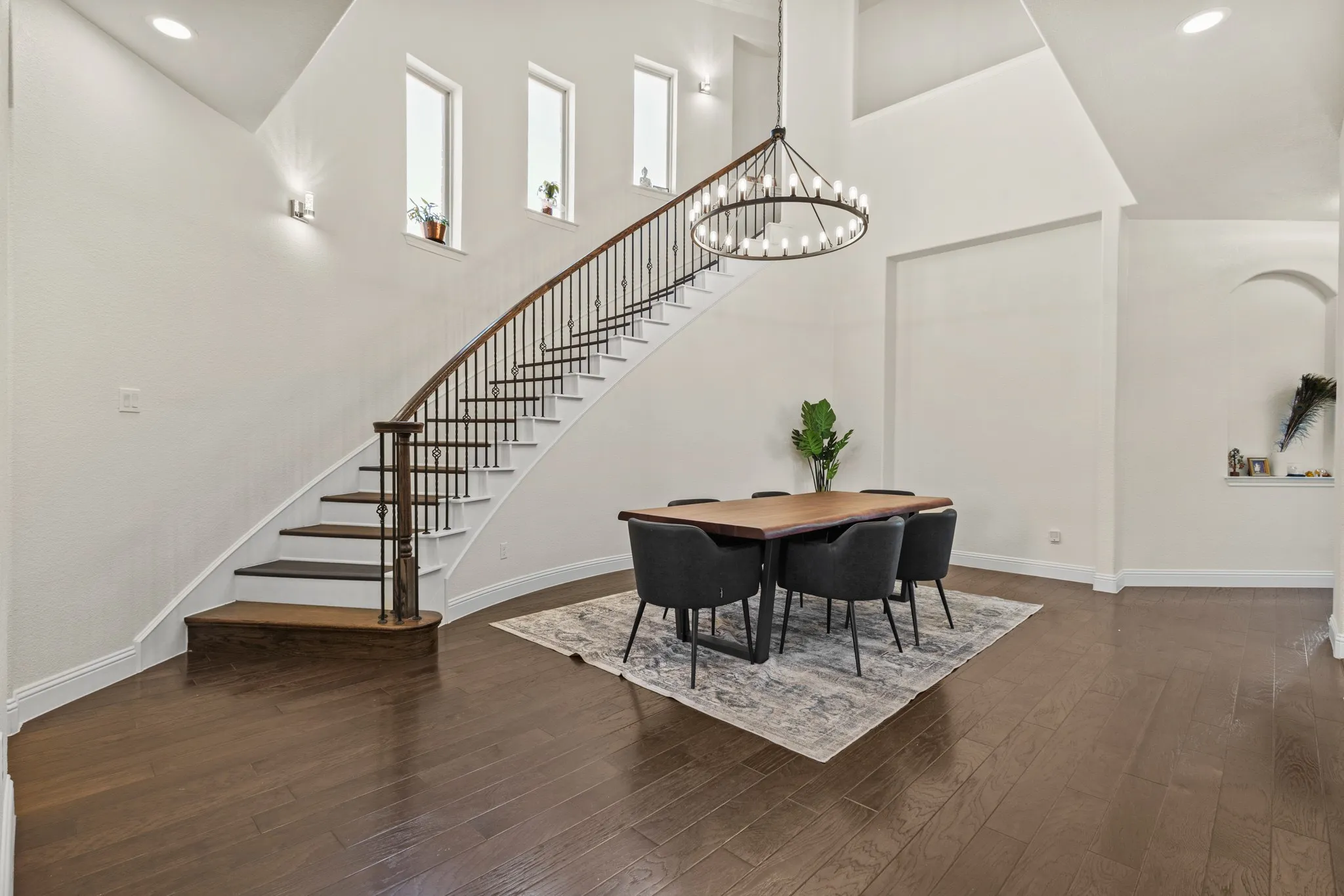 Dining room featuring stairs, a chandelier, wood finished floors, baseboards, and recessed lighting