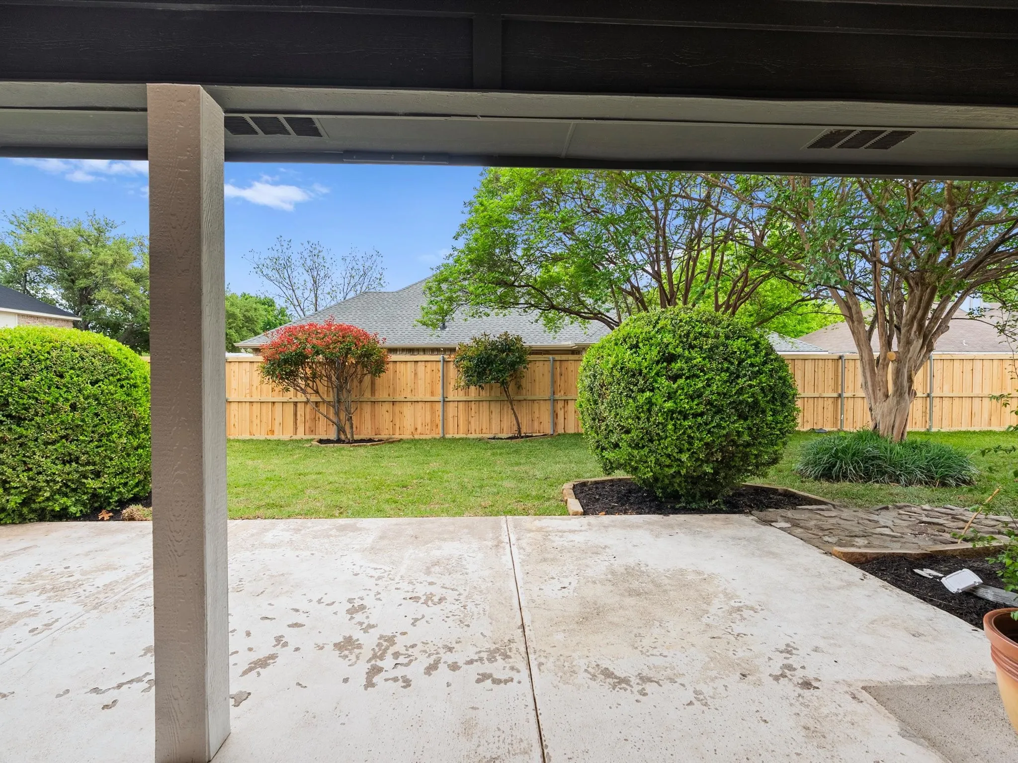 Fenced backyard with a patio