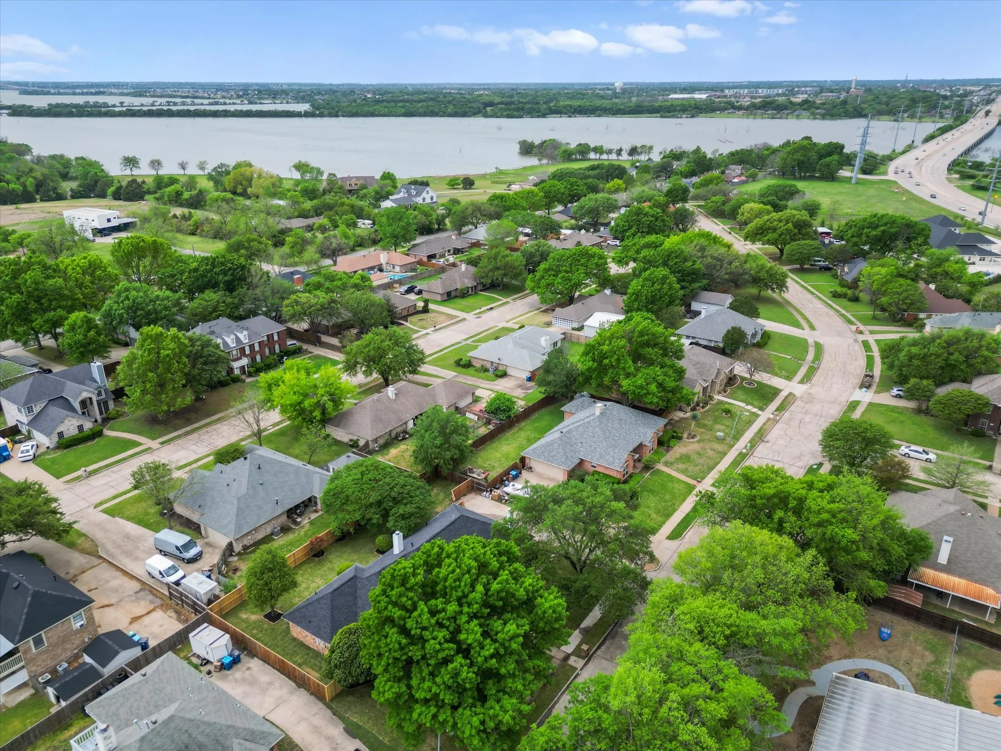 Aerial view of residential area featuring a nearby body of water