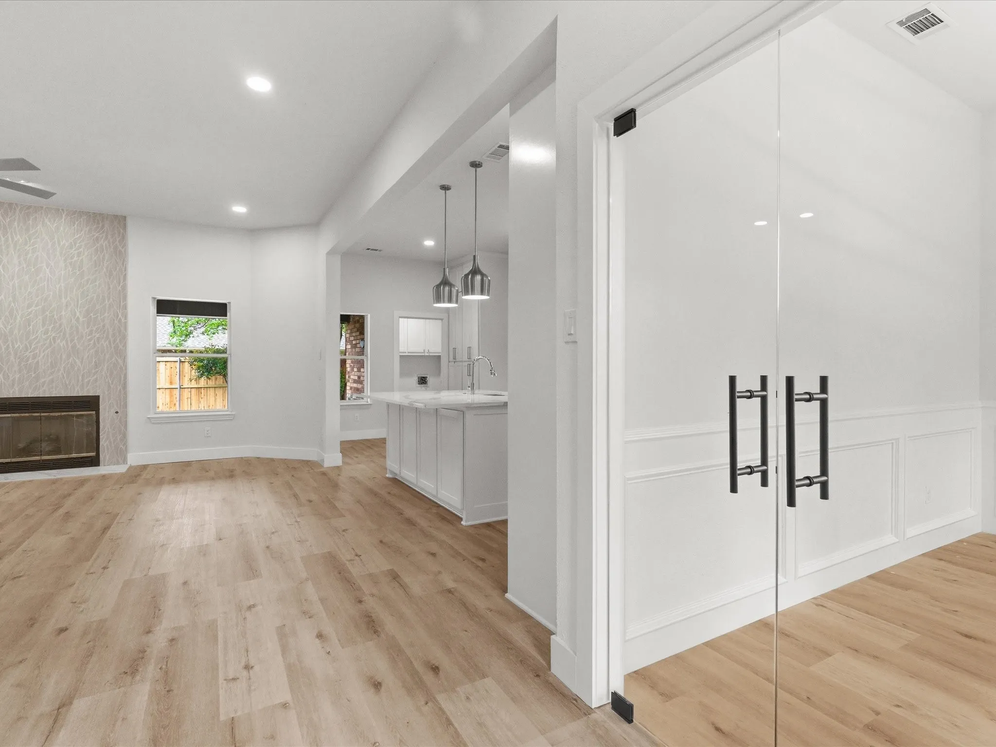 Unfurnished living room with a fireplace, light wood finished floors, and recessed lighting