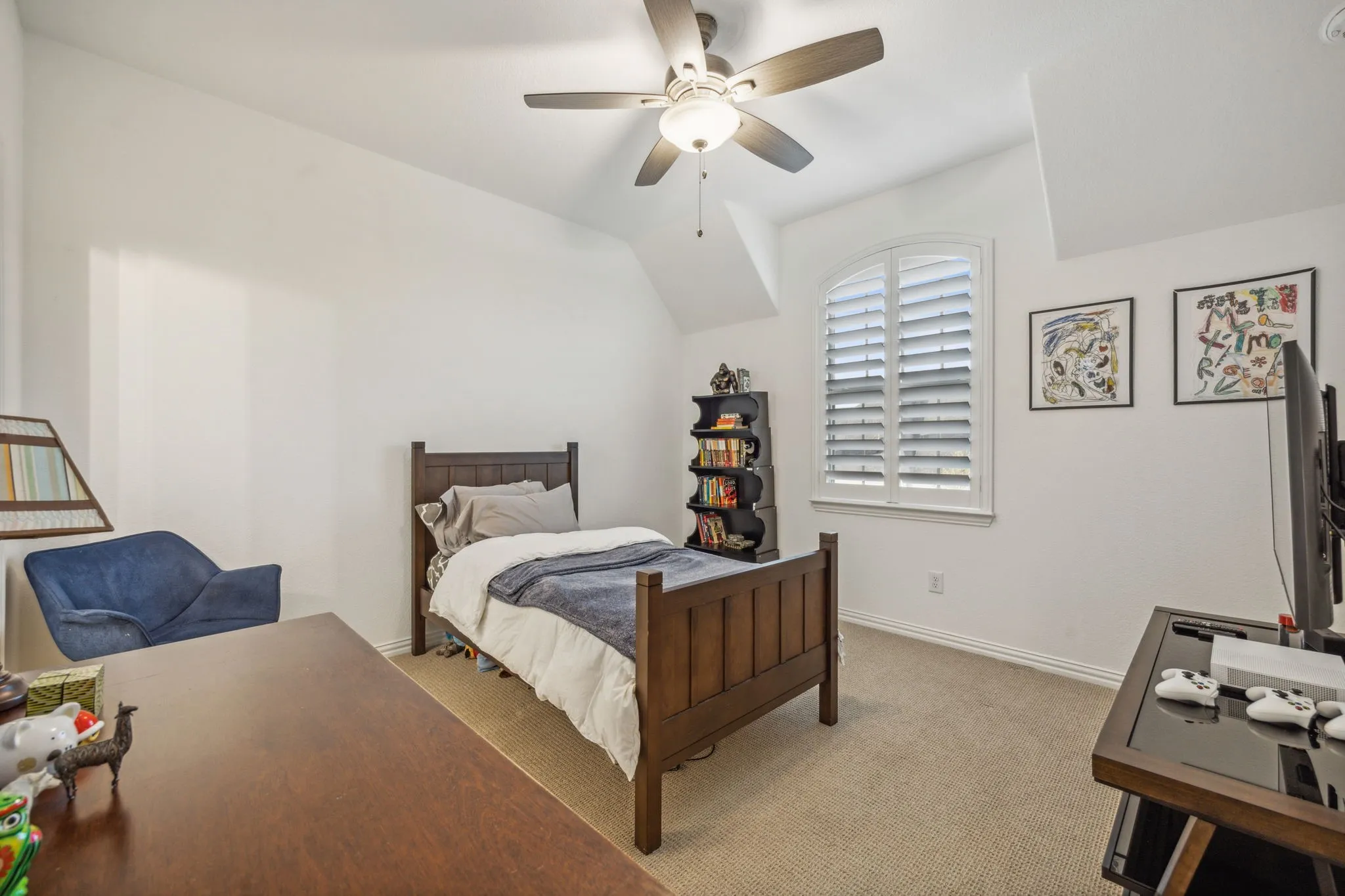 Carpeted bedroom with ceiling fan