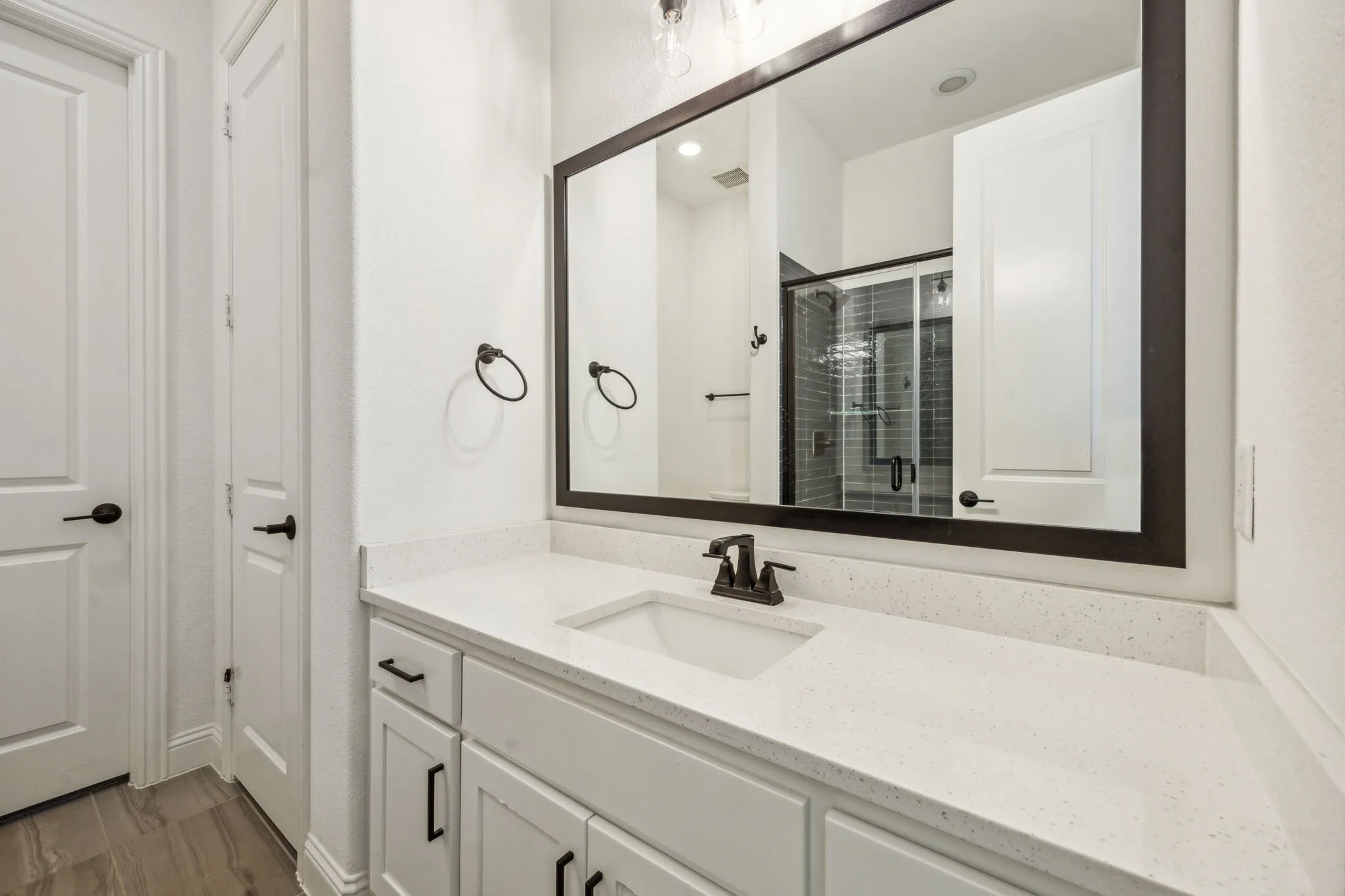 Bathroom featuring vanity and a shower with door
