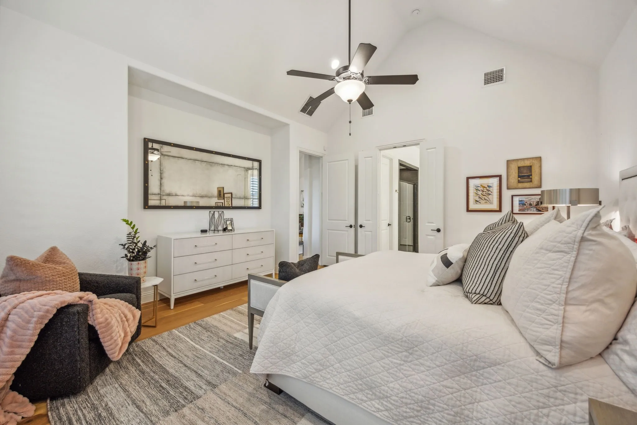 Bedroom with high vaulted ceiling, light hardwood / wood-style flooring, and ceiling fan