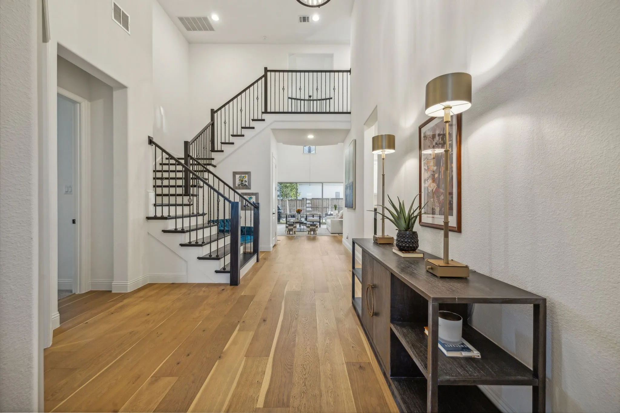 Foyer entrance featuring light hardwood / wood-style floors and a high ceiling