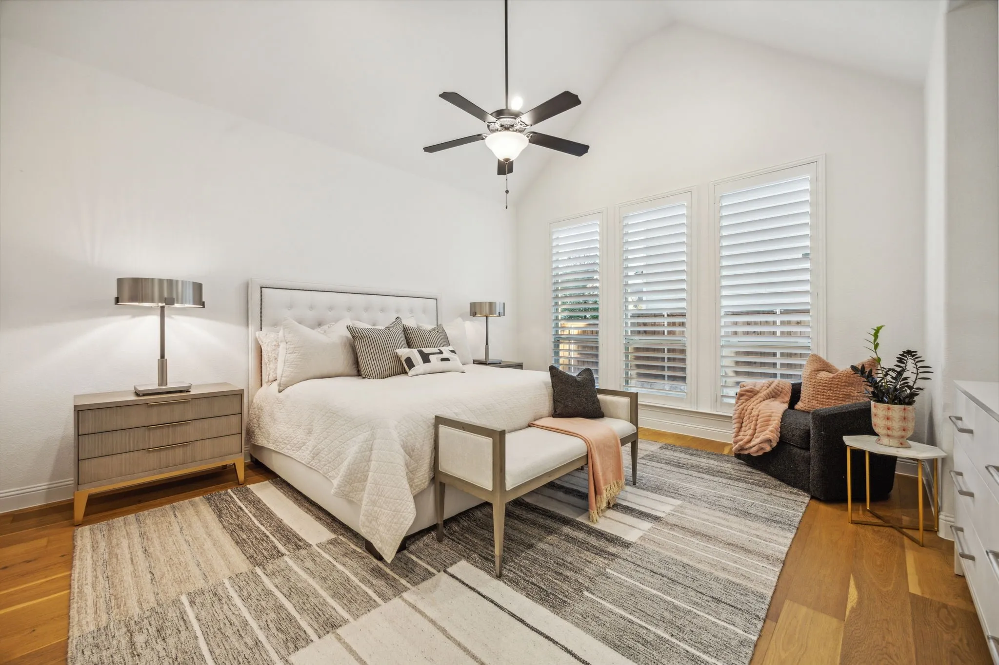 Bedroom with hardwood / wood-style flooring, ceiling fan, and vaulted ceiling