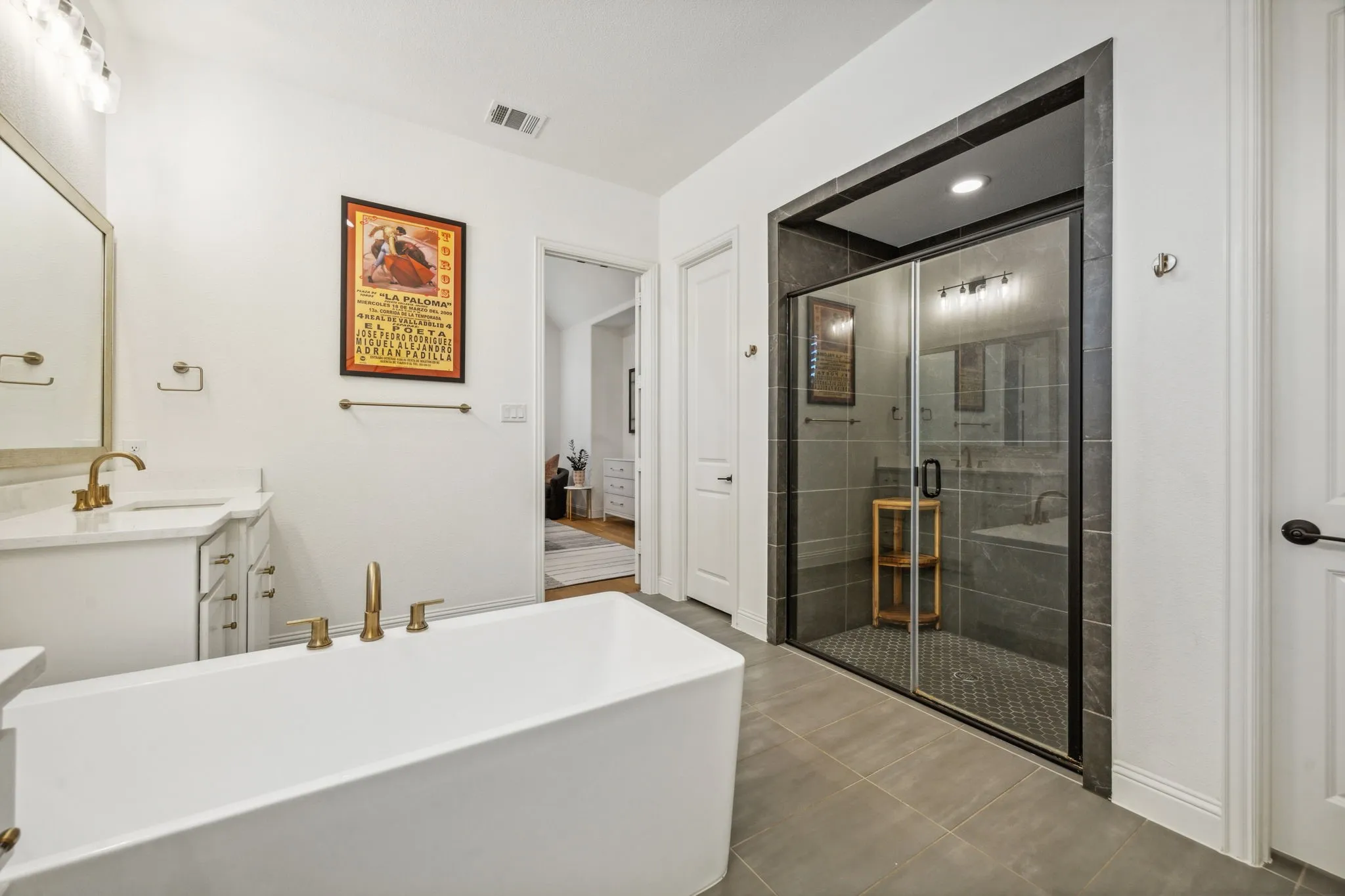 Bathroom with tile patterned flooring, vanity, and plus walk in shower