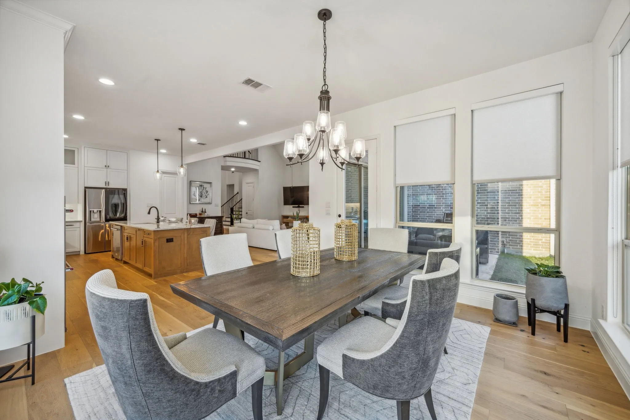 Dining area with a chandelier, light hardwood / wood-style floors, and sink