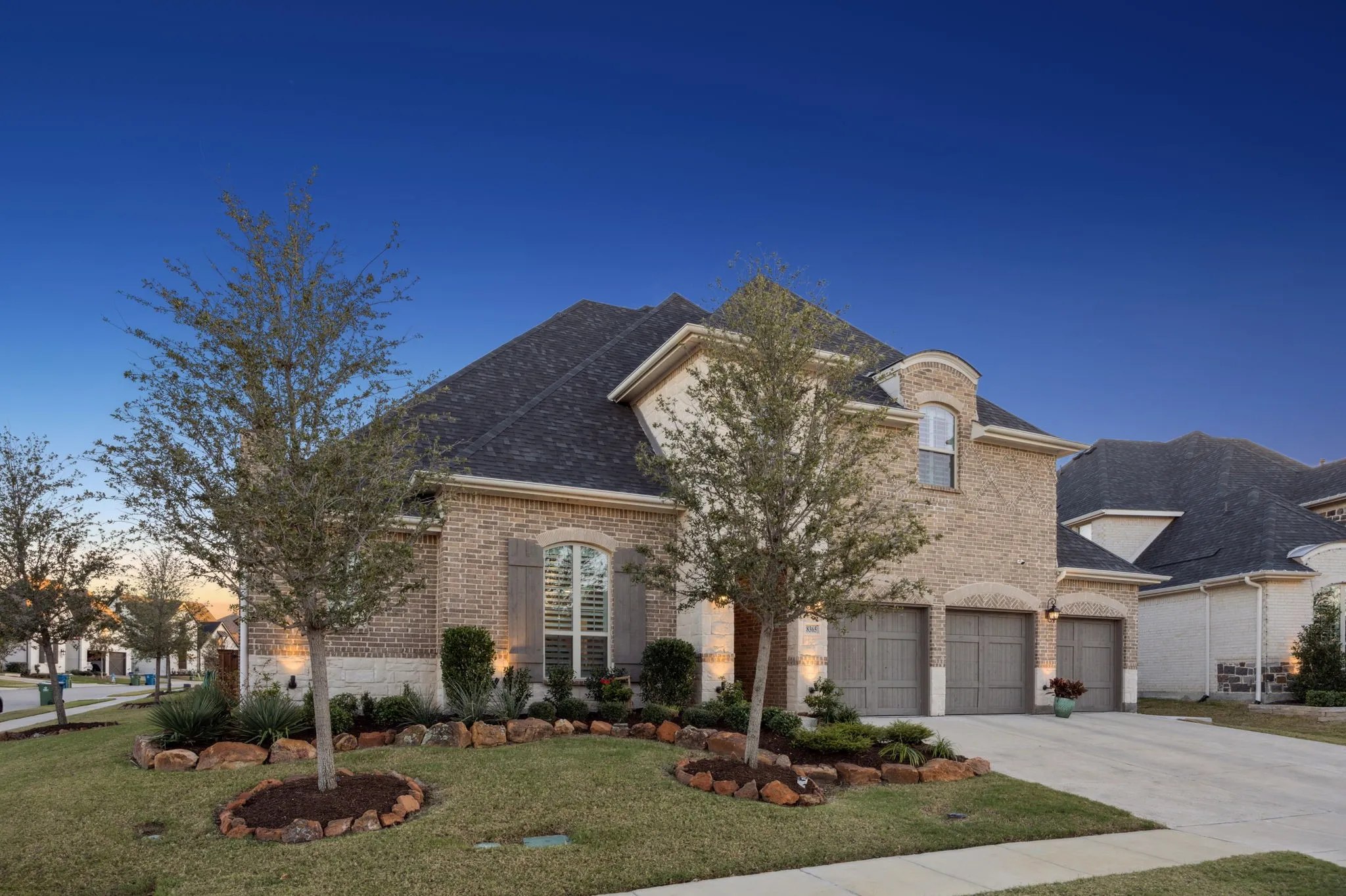 French country style house featuring a garage and a yard