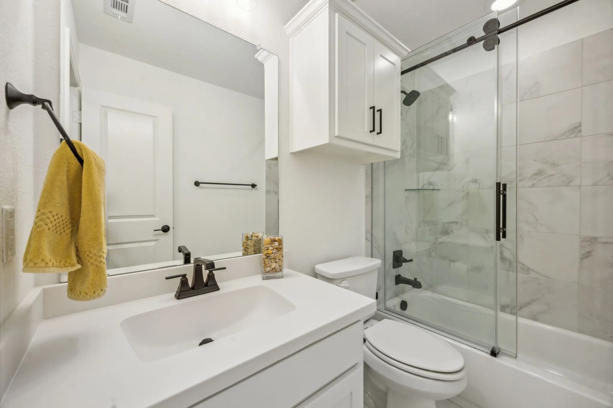 Full bathroom featuring vanity, toilet, and enclosed tub / shower combo