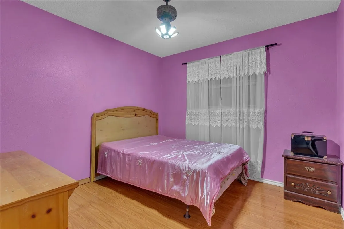 Bedroom with light wood-style flooring and baseboards